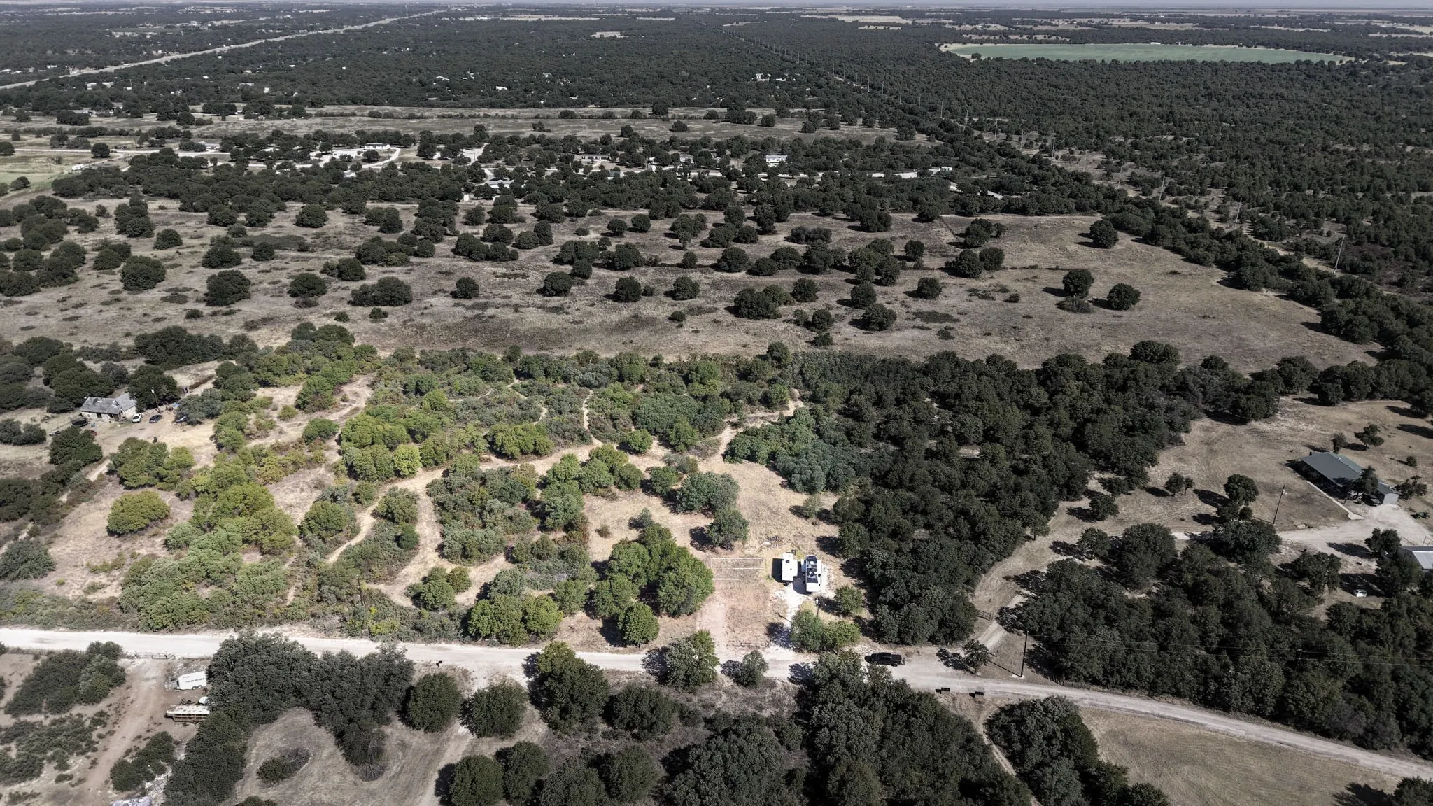 Expansive acreage featuring mature trees and a substantial wooded area