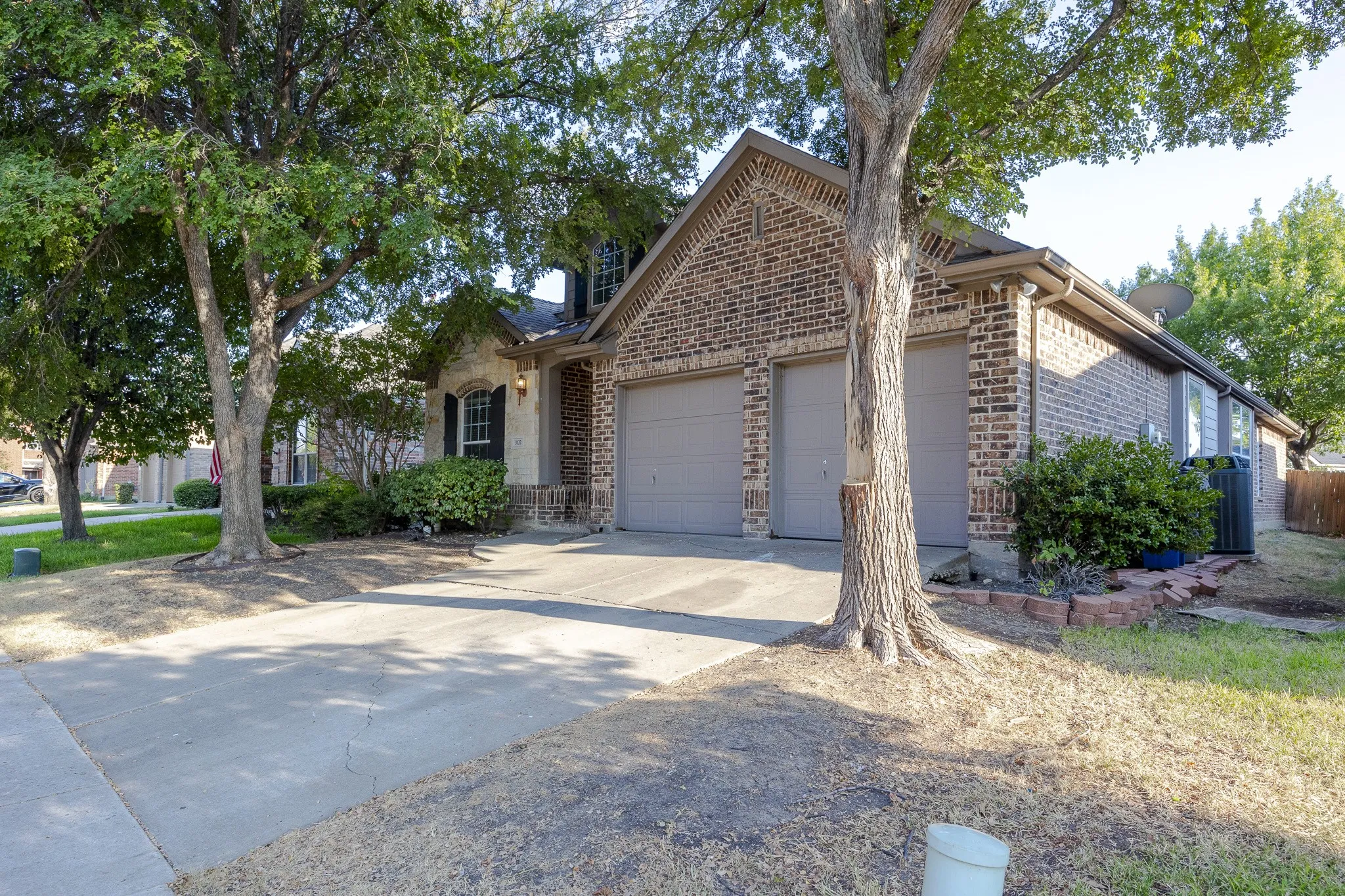 Brick and stone exterior with a two-car garage