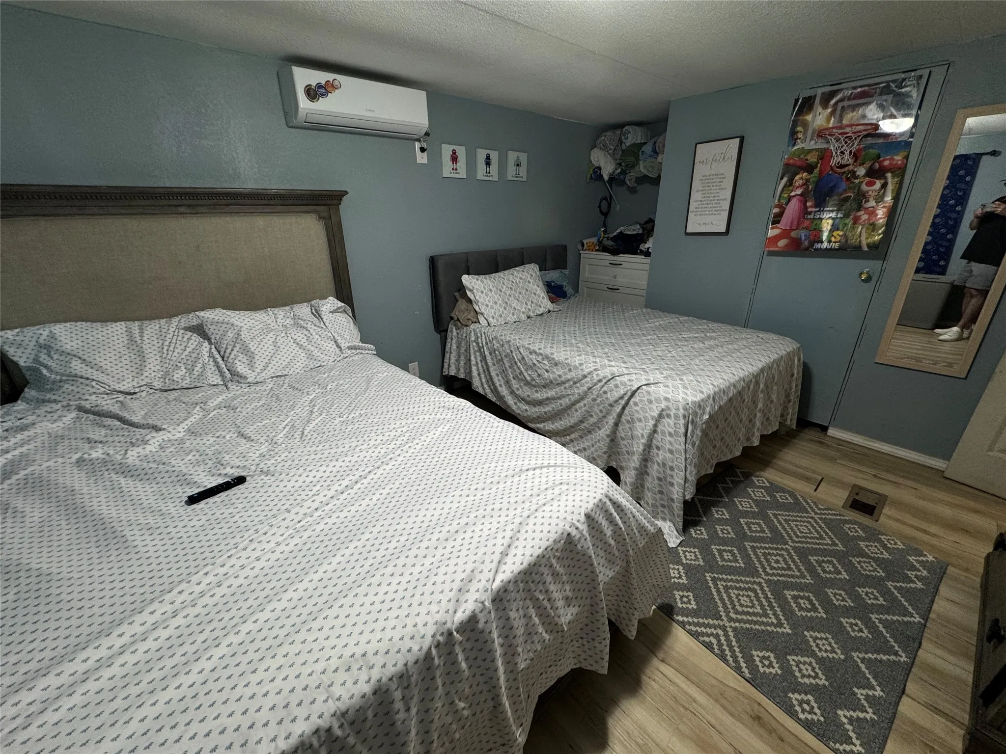 Room featuring wood-finish flooring and light blue walls