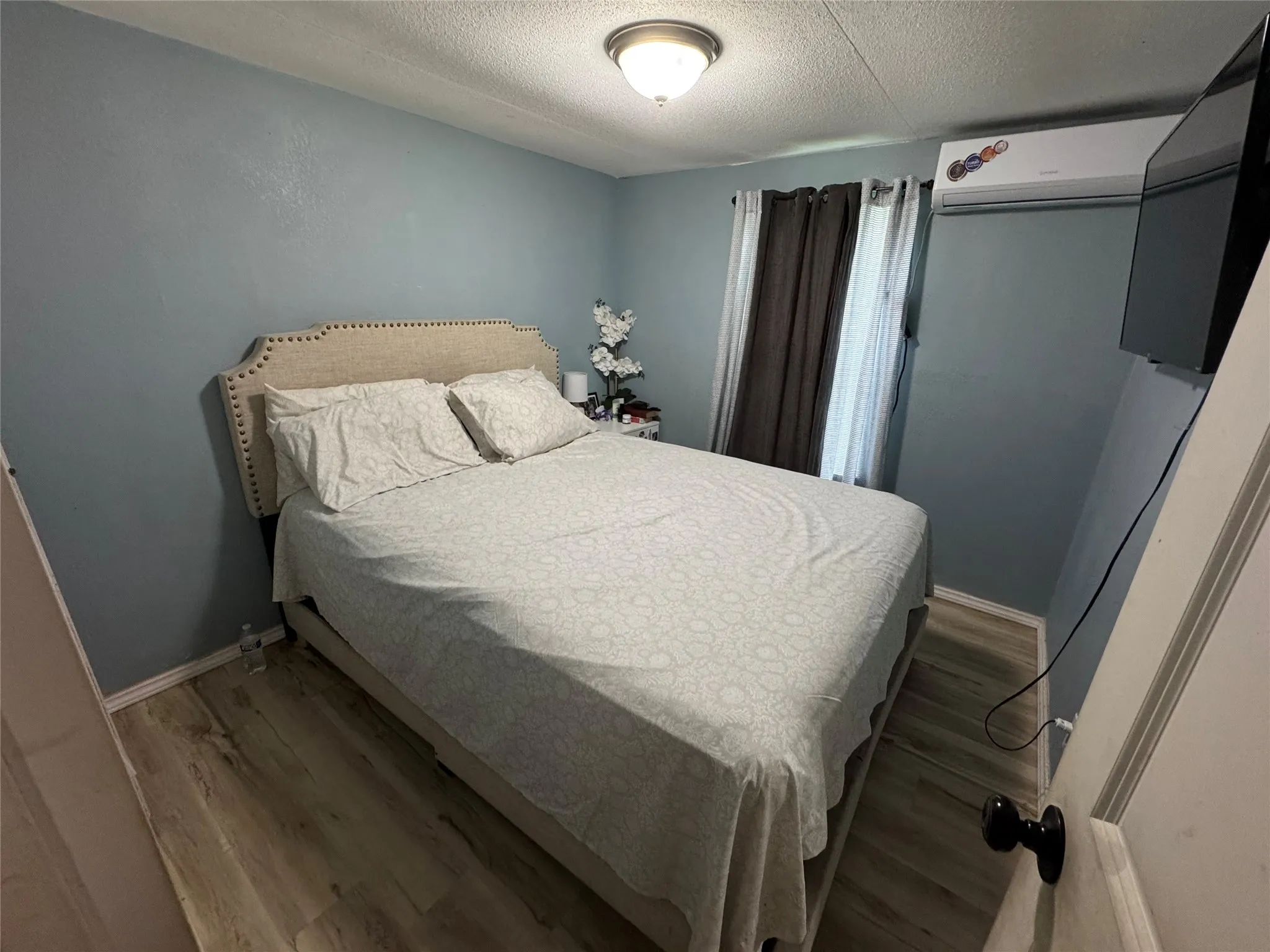 Light blue walls with wood-finish flooring