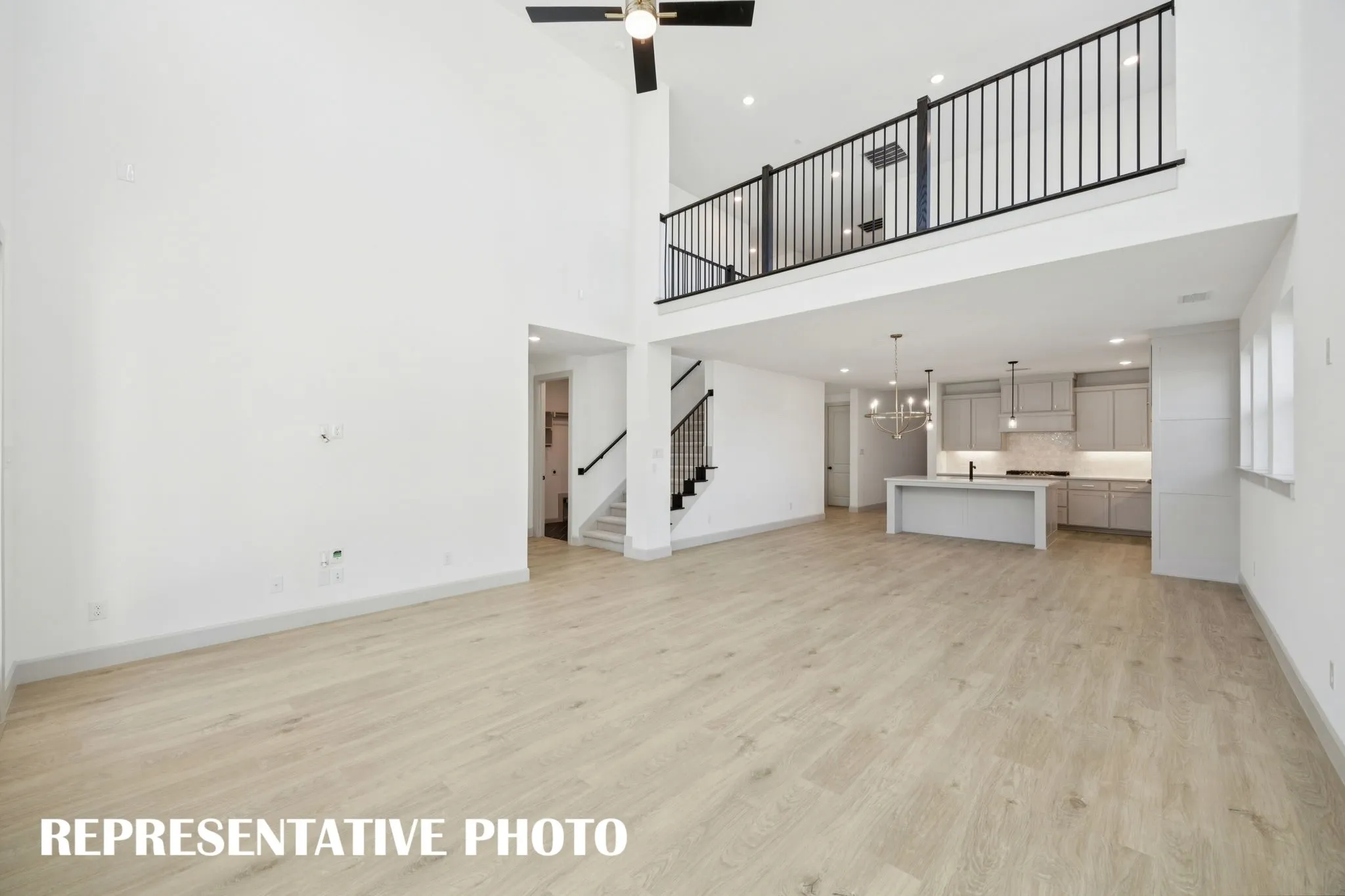 Our Versailles plan features a game room with open railing that overlooks the family room below creating a multi-level entertainment area!  REPRESENTATIVE PHOTO
