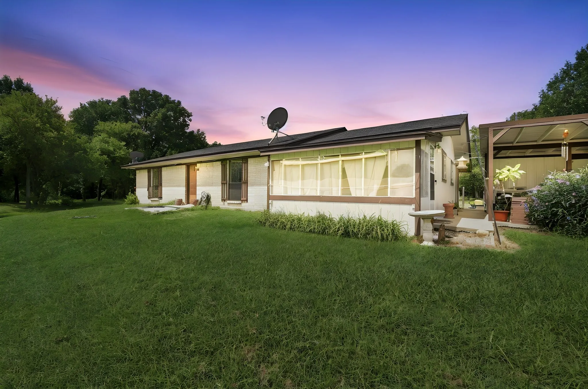 Single-story residence featuring a dark roofline and light-colored siding