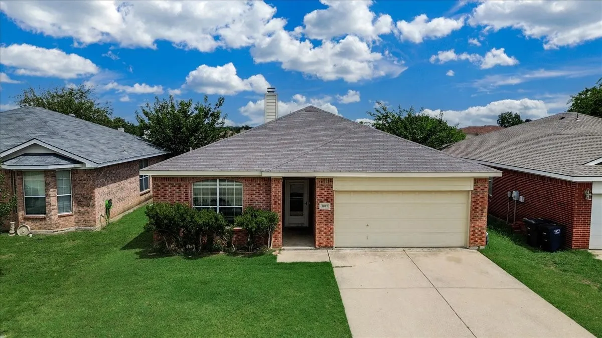 Brick exterior residence with an attached garage, and covered entryway