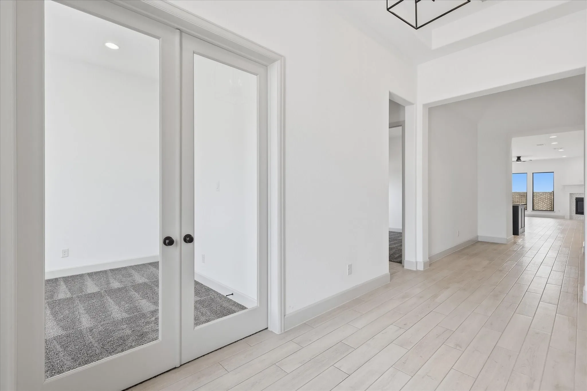Entryway featuring light wood-finish flooring, white walls, and a contemporary ceiling light fixture