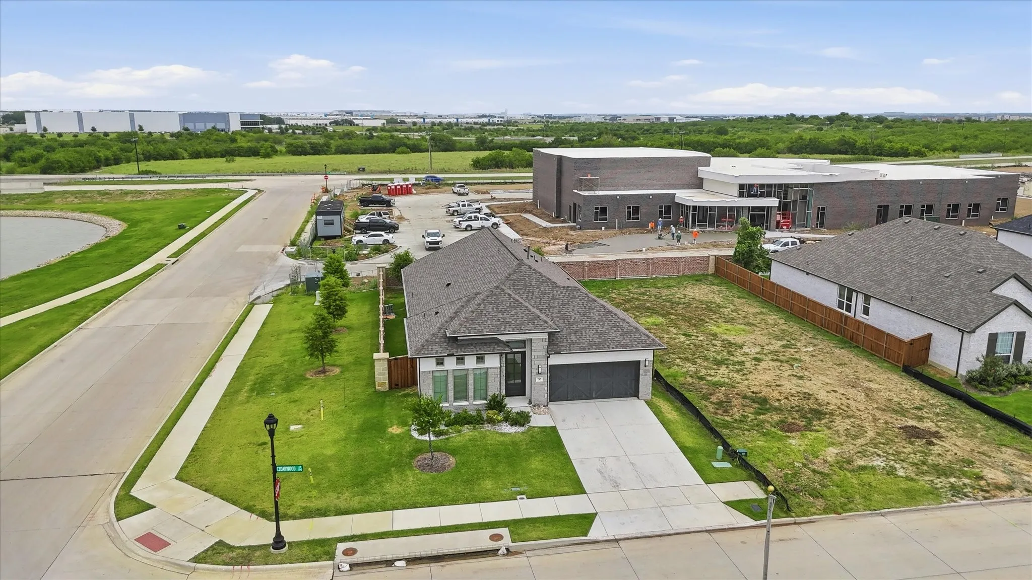 Contemporary single-story residence featuring a two-car garage, concrete driveway, and front landscaping