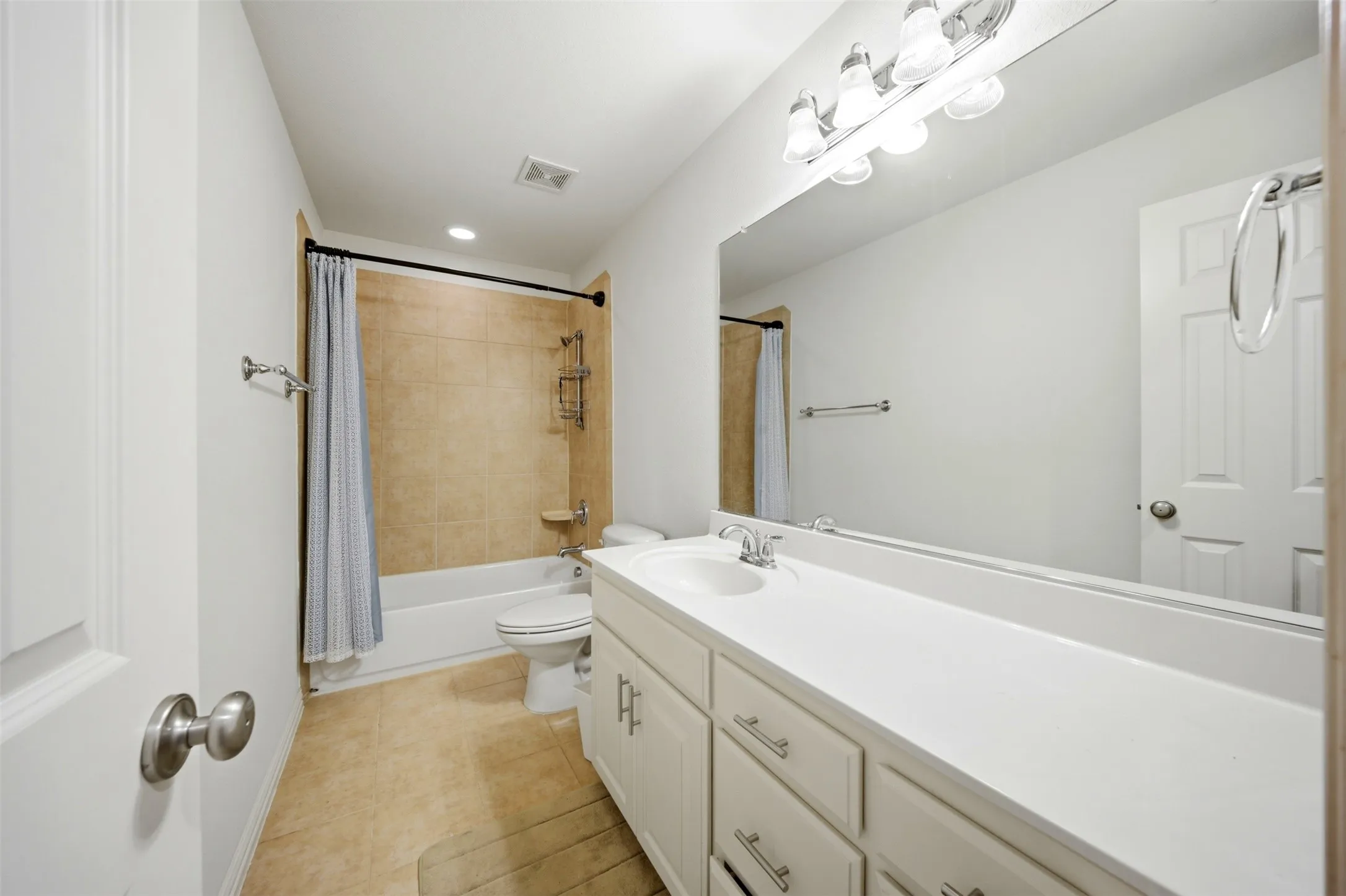Extended single vanity with integrated sink, chrome faucet, and white cabinetry