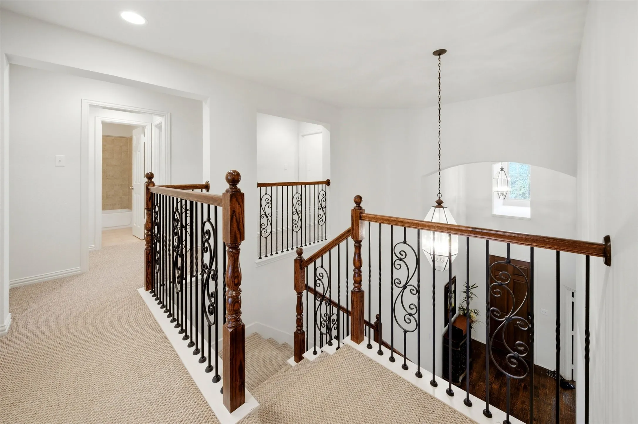Upper-level landing featuring neutral carpeting and recessed lighting