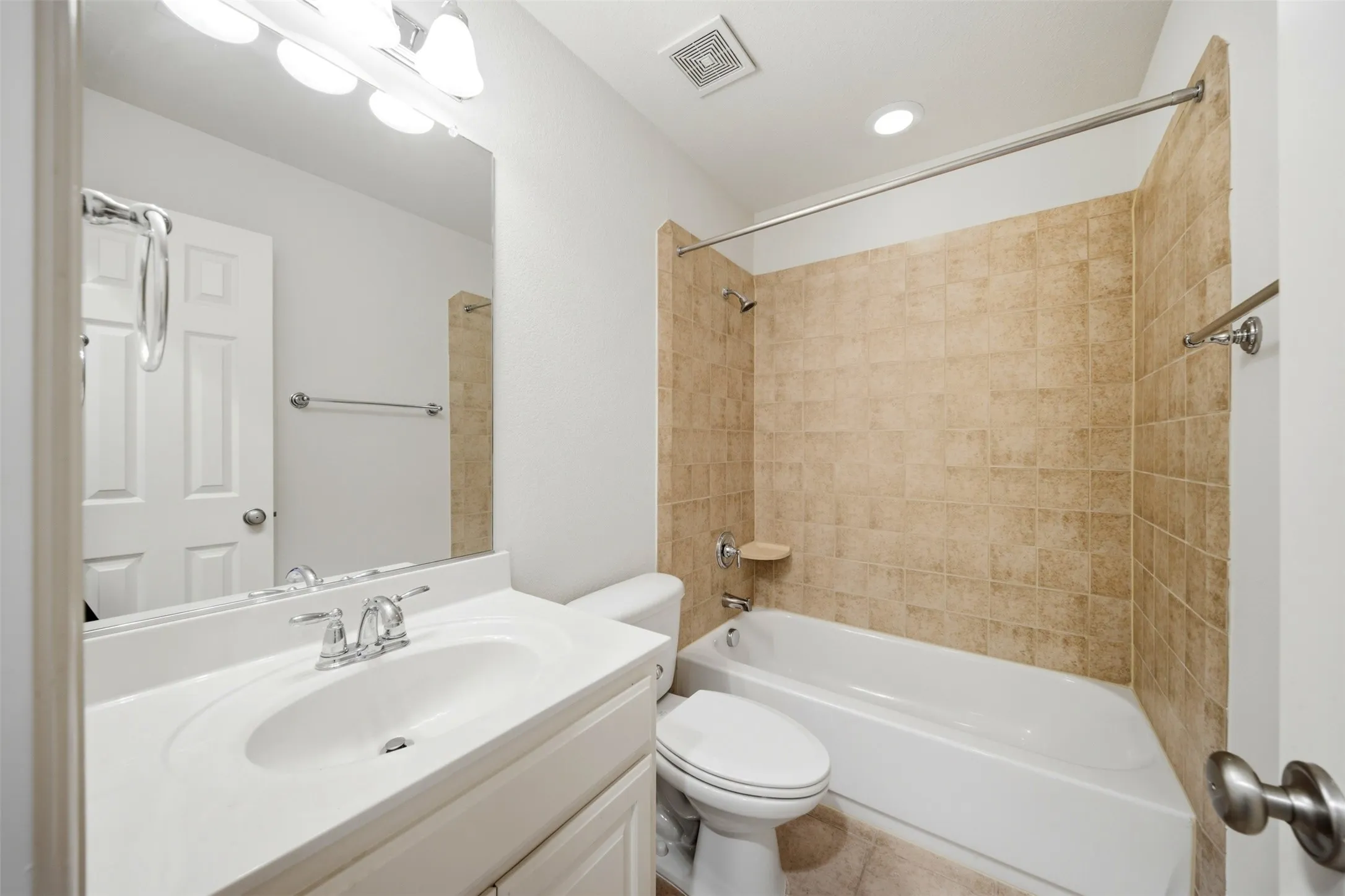 Vanity with integrated sink, chrome-finish faucet, and overhead bar lighting