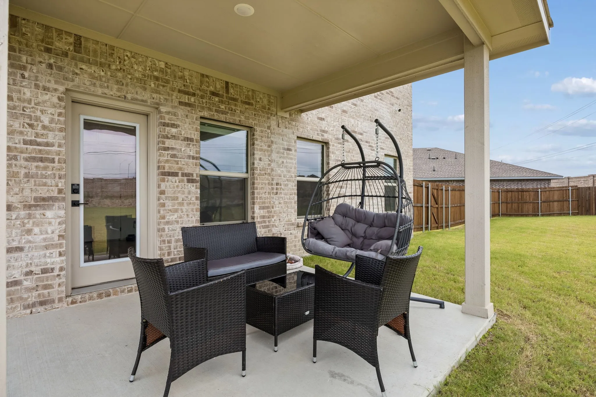Covered patio featuring a concrete slab and ceiling-mounted lighting