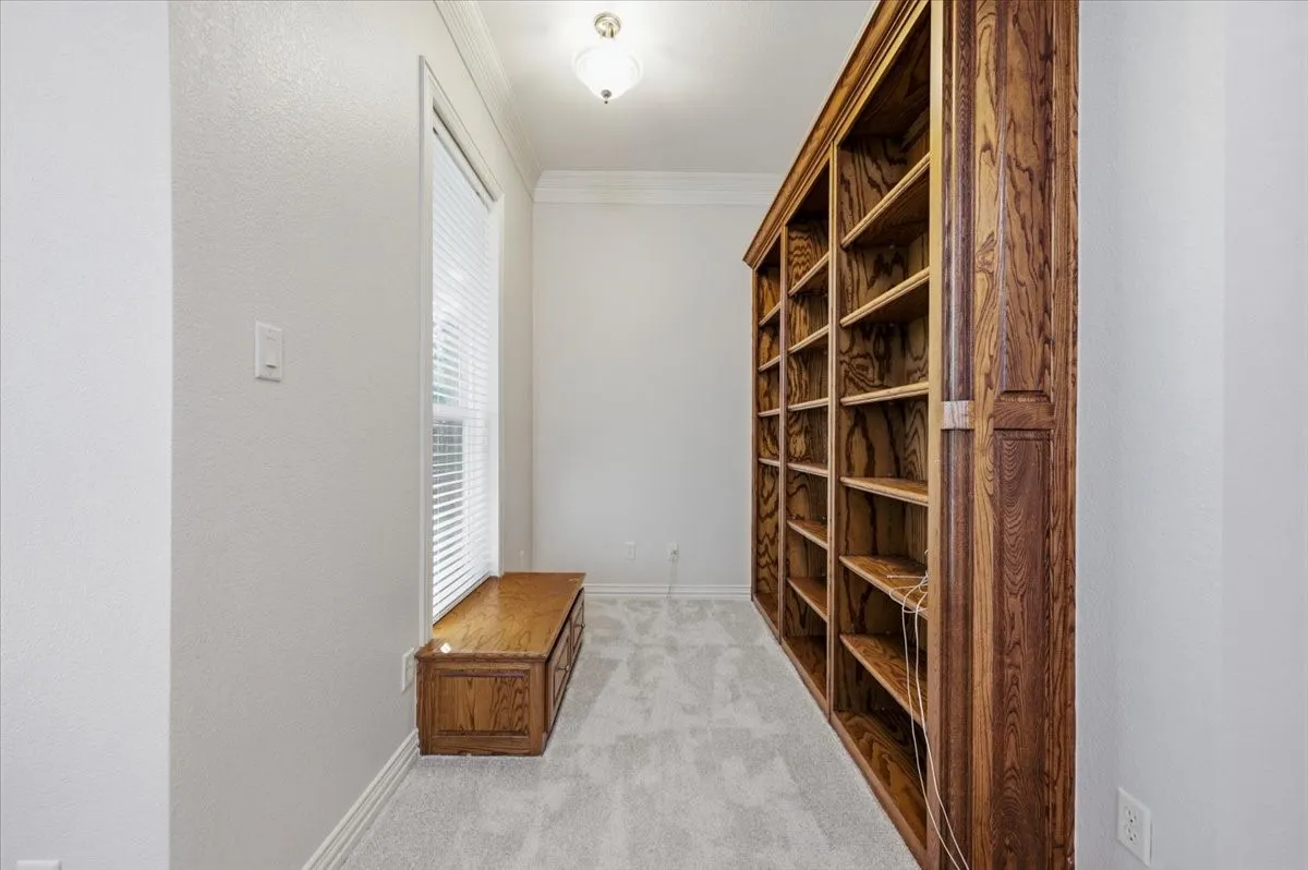 Built in shelves with a trunk and space for a desk