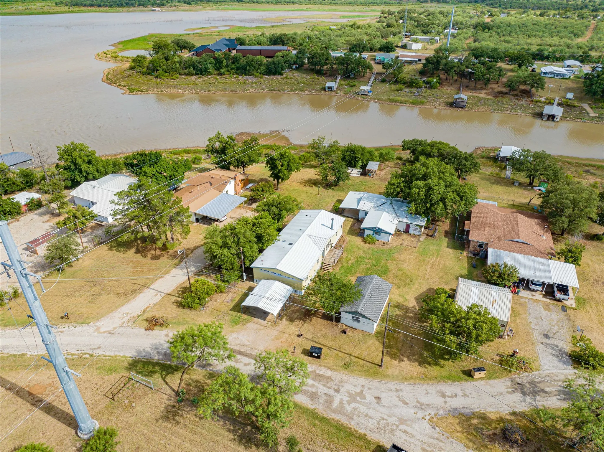 Aerial perspective showcasing residential properties bordering a body of water