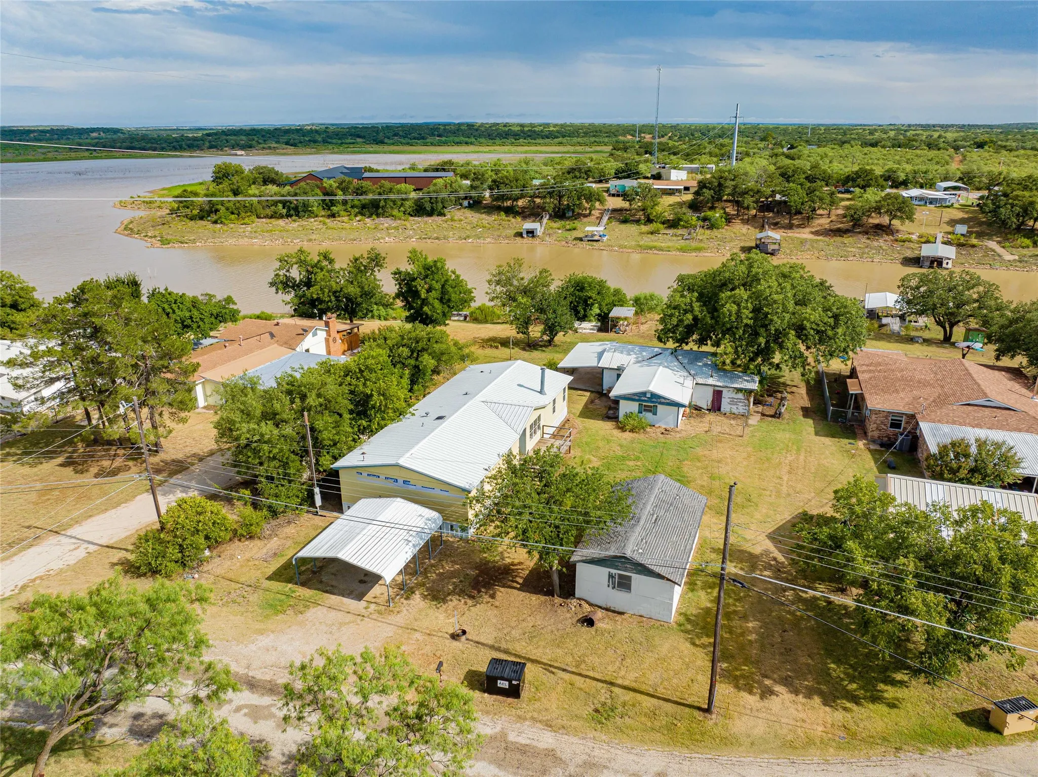 Expansive property featuring multiple structures and a waterfront location
