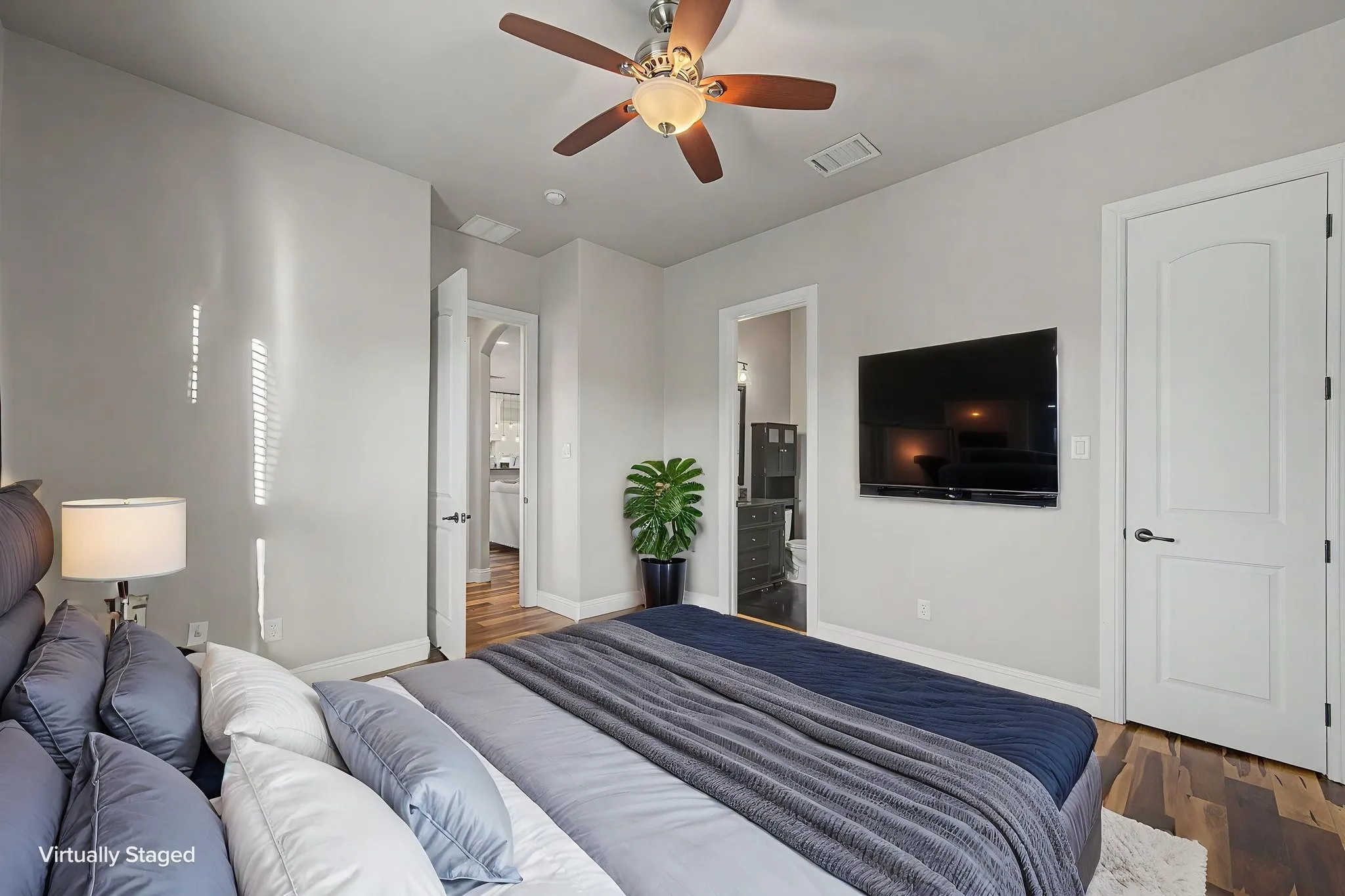 Main-level secondary bedroom with an ensuite bath, providing a private bedroom and bath configuration.