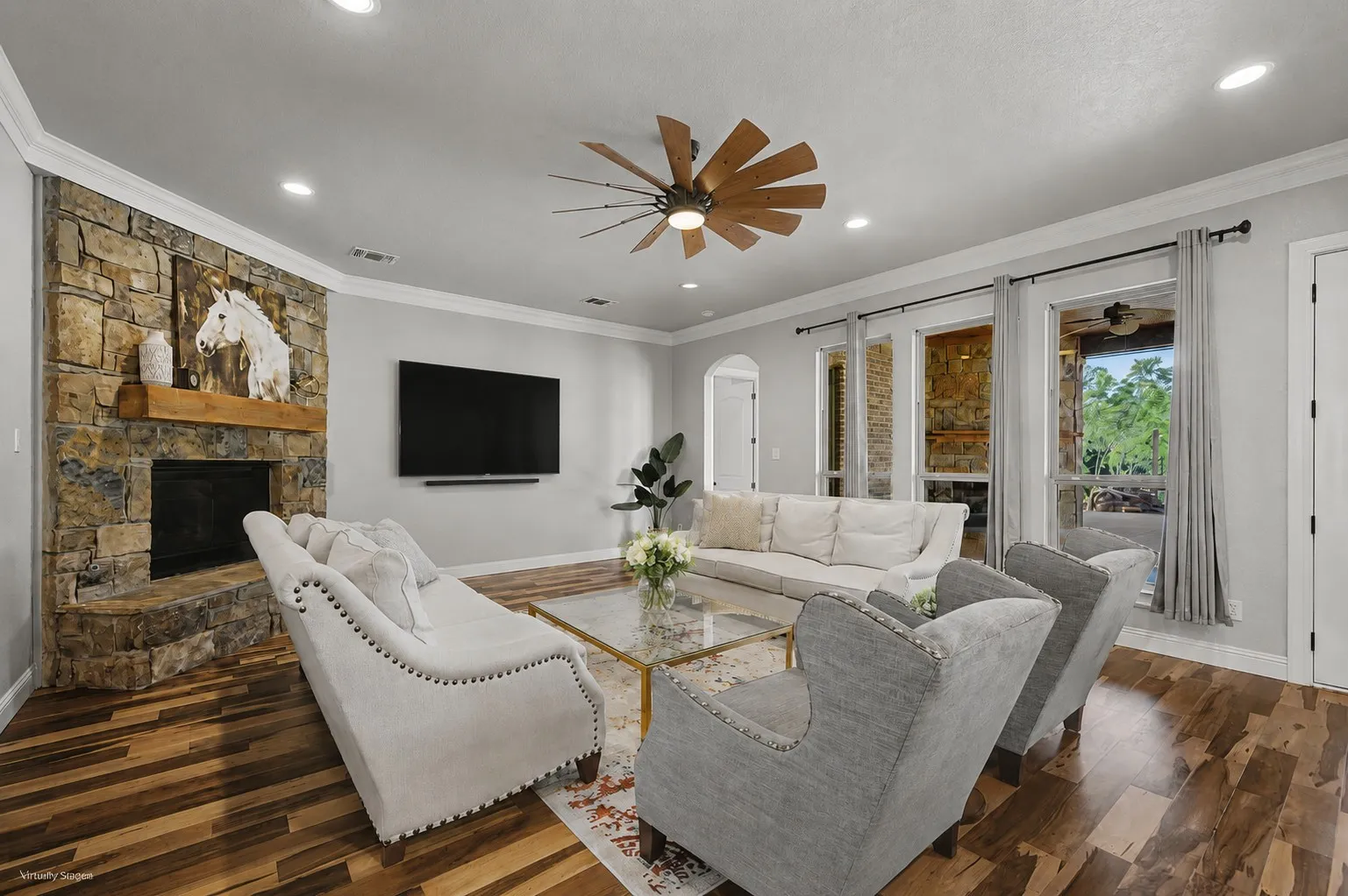 Spacious main living area with an open layout, updated flooring, abundant natural light, and views of the backyard.