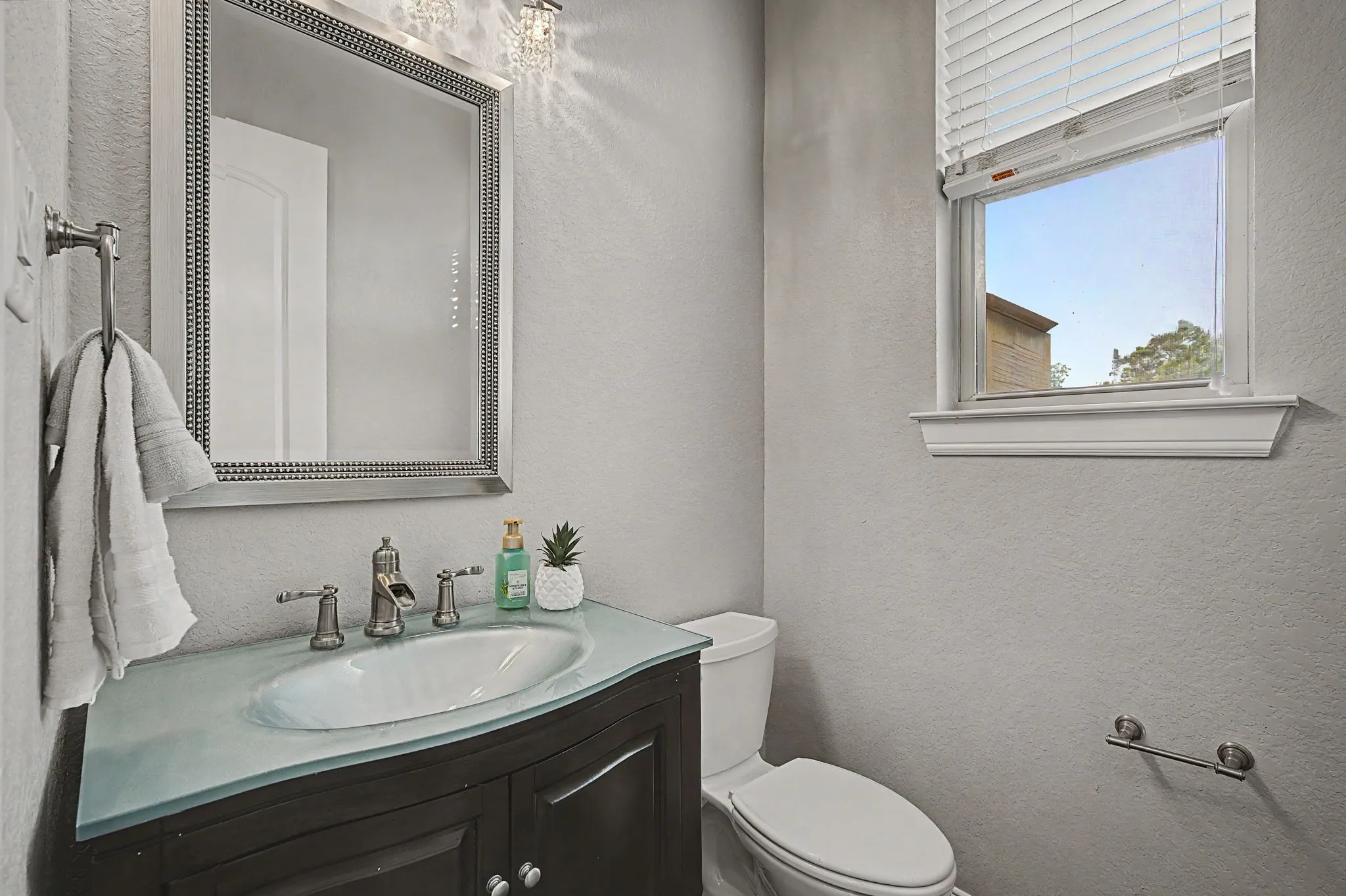 Main level powder bath just off the living room with access to the covered patio and pool