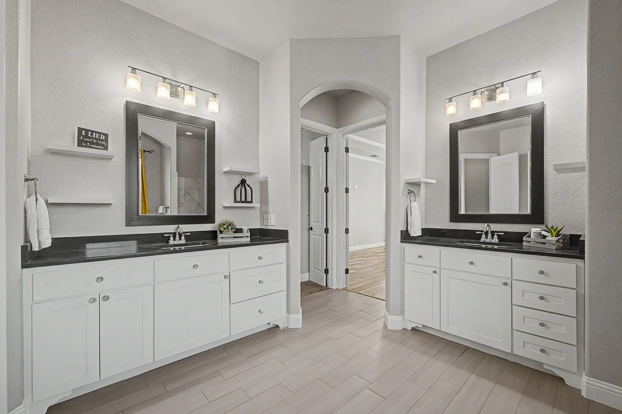 Primary bath features a spacious layout with separate vanities, soaking tub, walk-in shower, and ample storage.