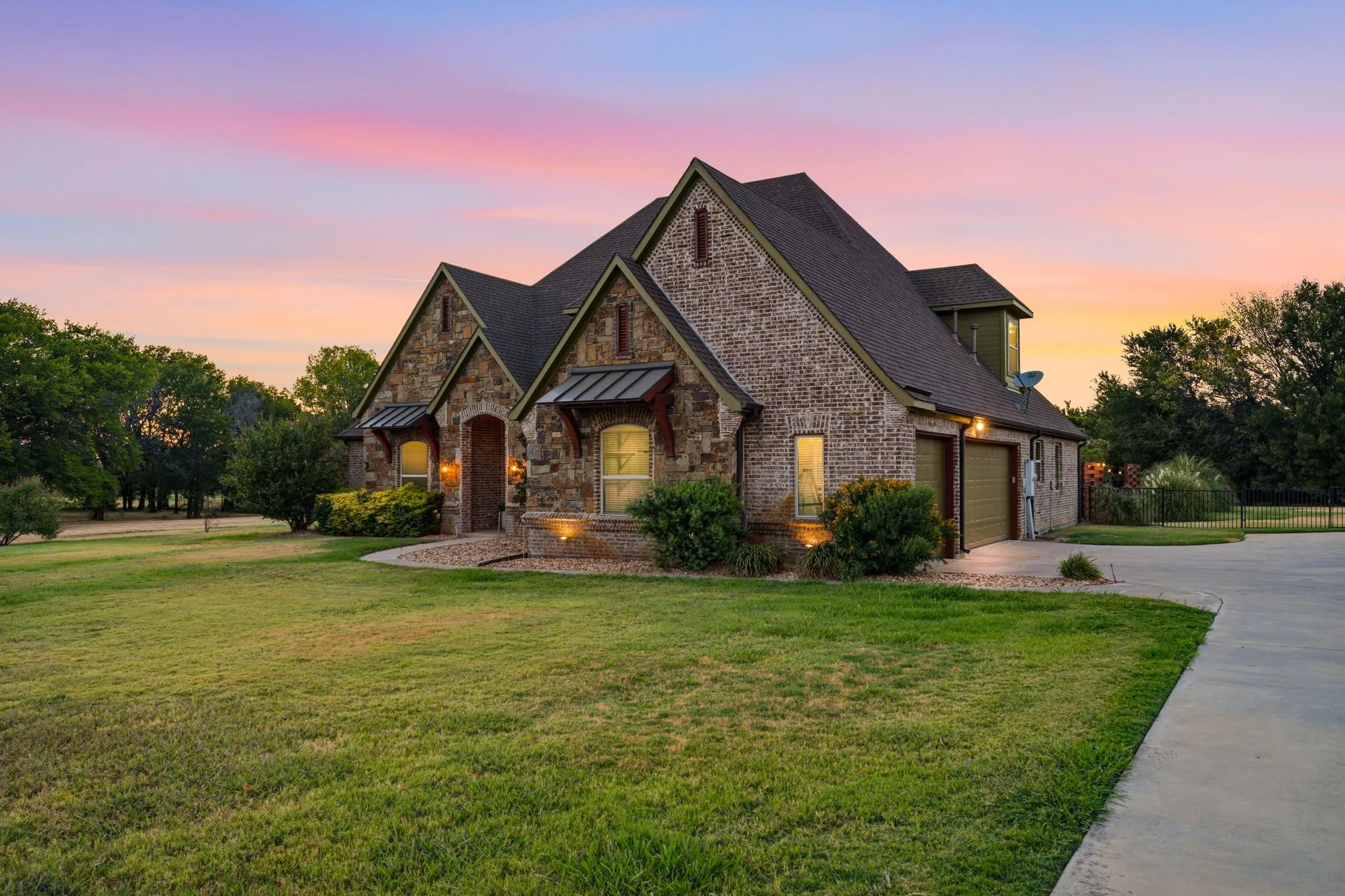 Additional exterior view showcasing the home’s architectural details, established landscaping, and generous lot.