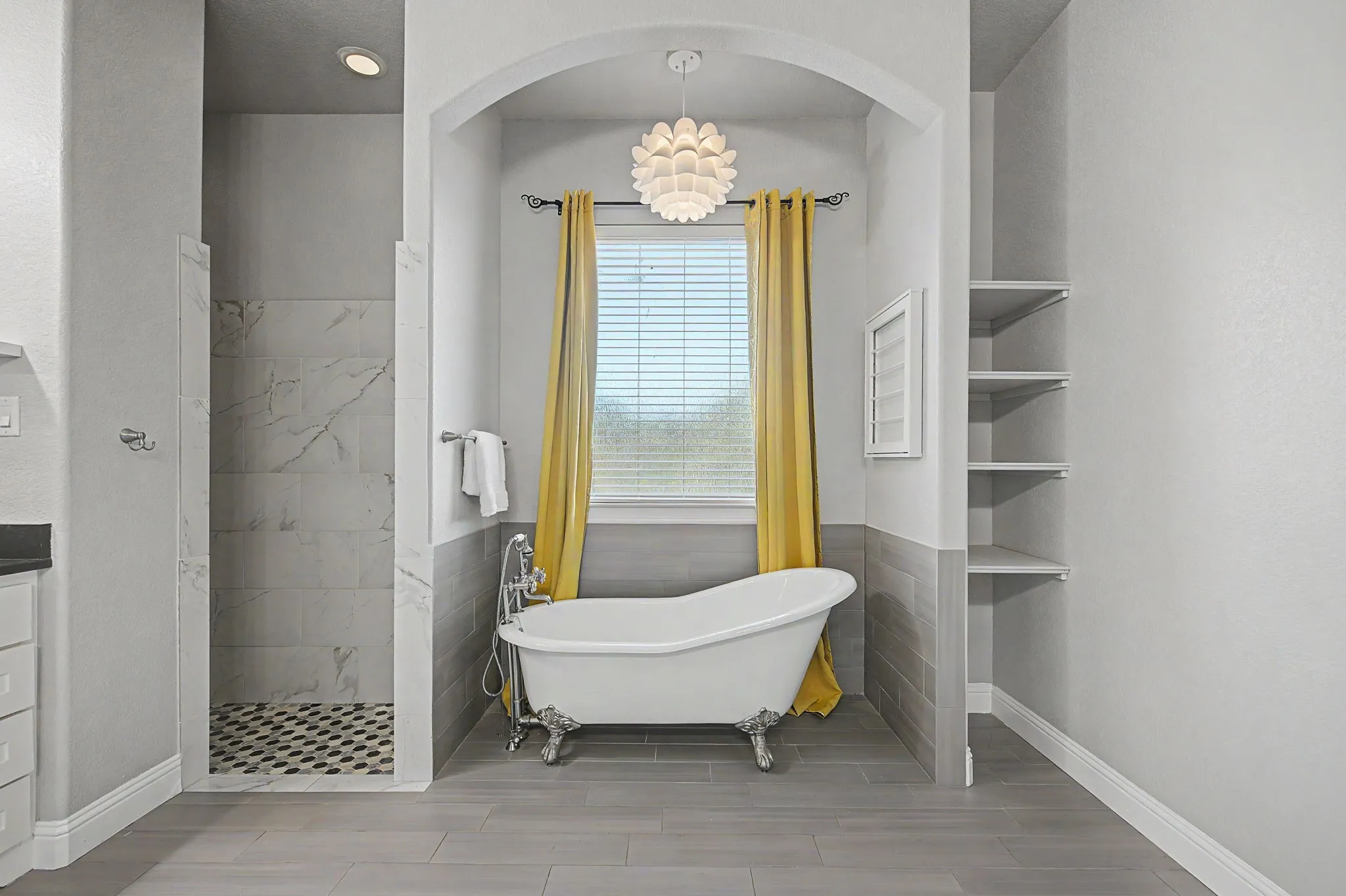 Primary bath features a spacious layout with separate vanities, soaking tub, walk-in shower, and ample storage.