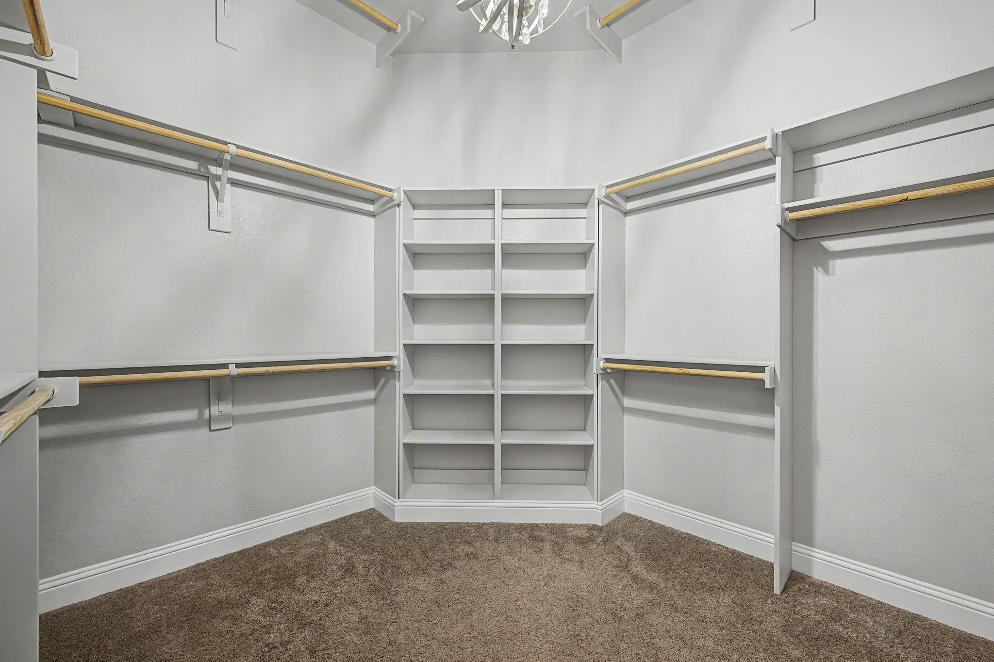 Primary Closet with decorative chandelier and plenty of space