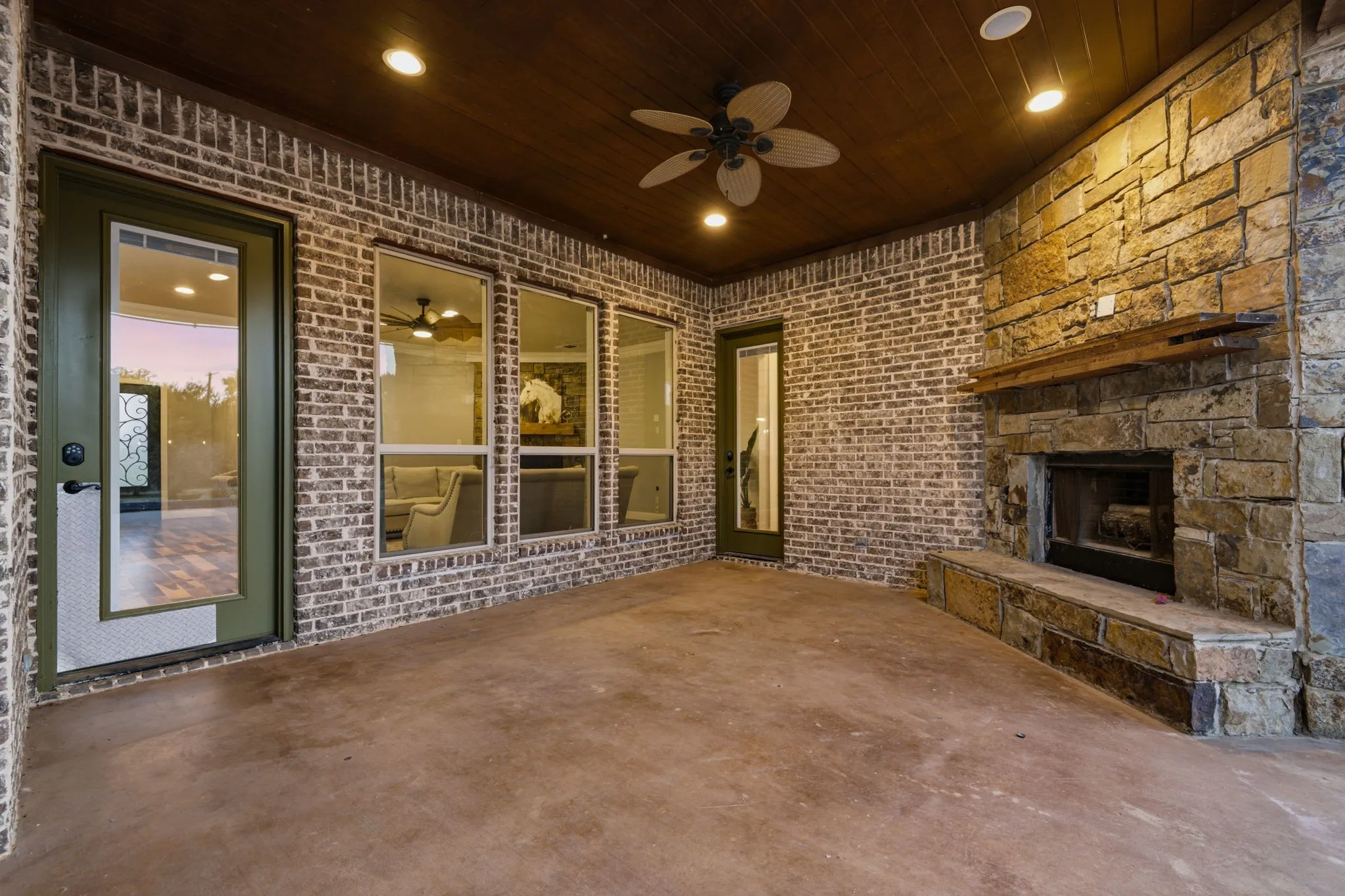 Covered outdoor living area overlooks the backyard and pool, providing additional space for outdoor dining and entertaining.
