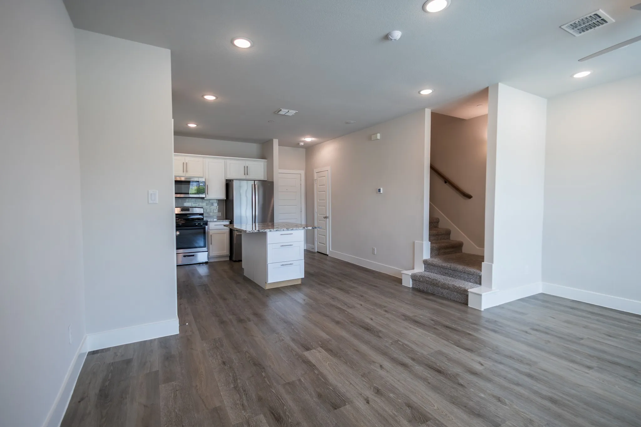 Downstairs has the same floors with dining flowing to kitchen and living area.
