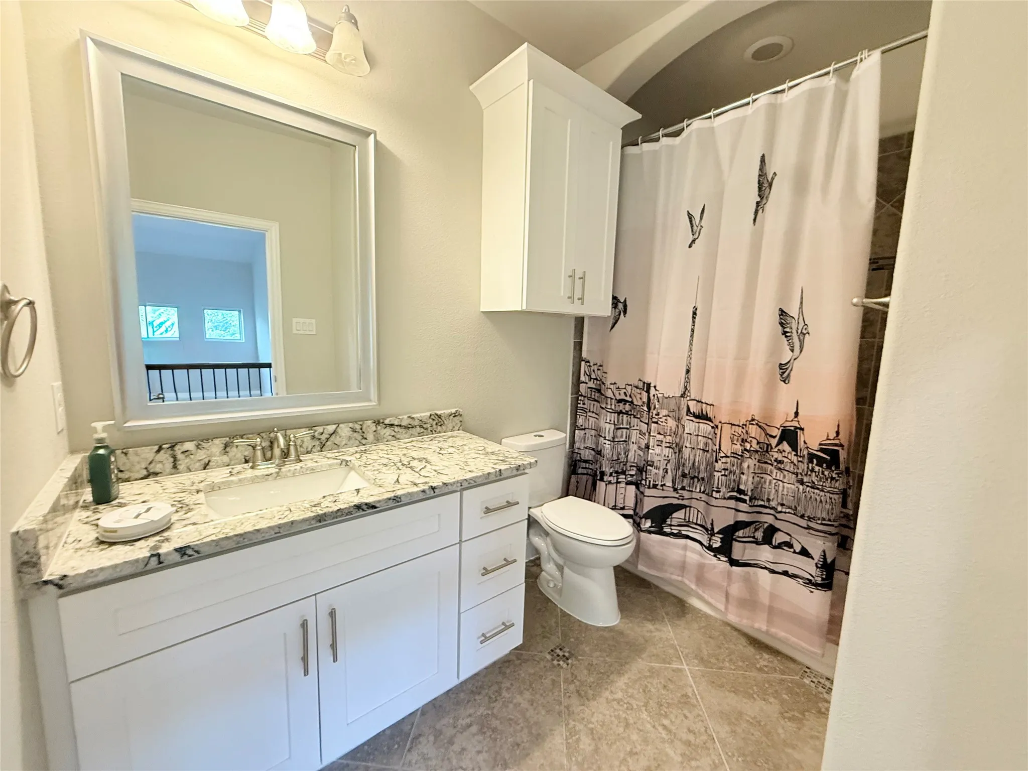 Bathroom featuring a white vanity with a granite countertop and an undermount sink