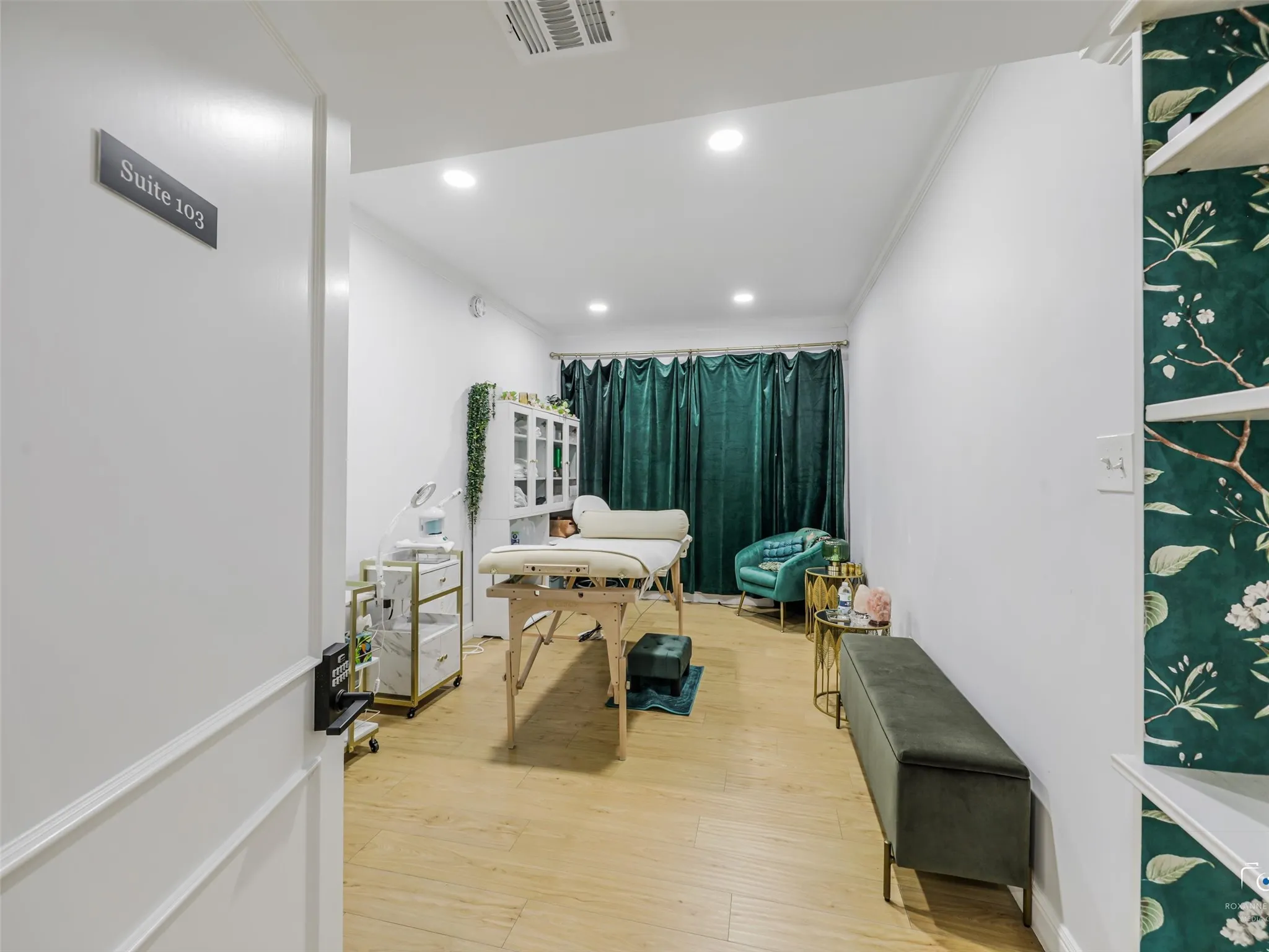 Suite 103 is occupied by an aesthetician.  There are windows beyond the drapes.