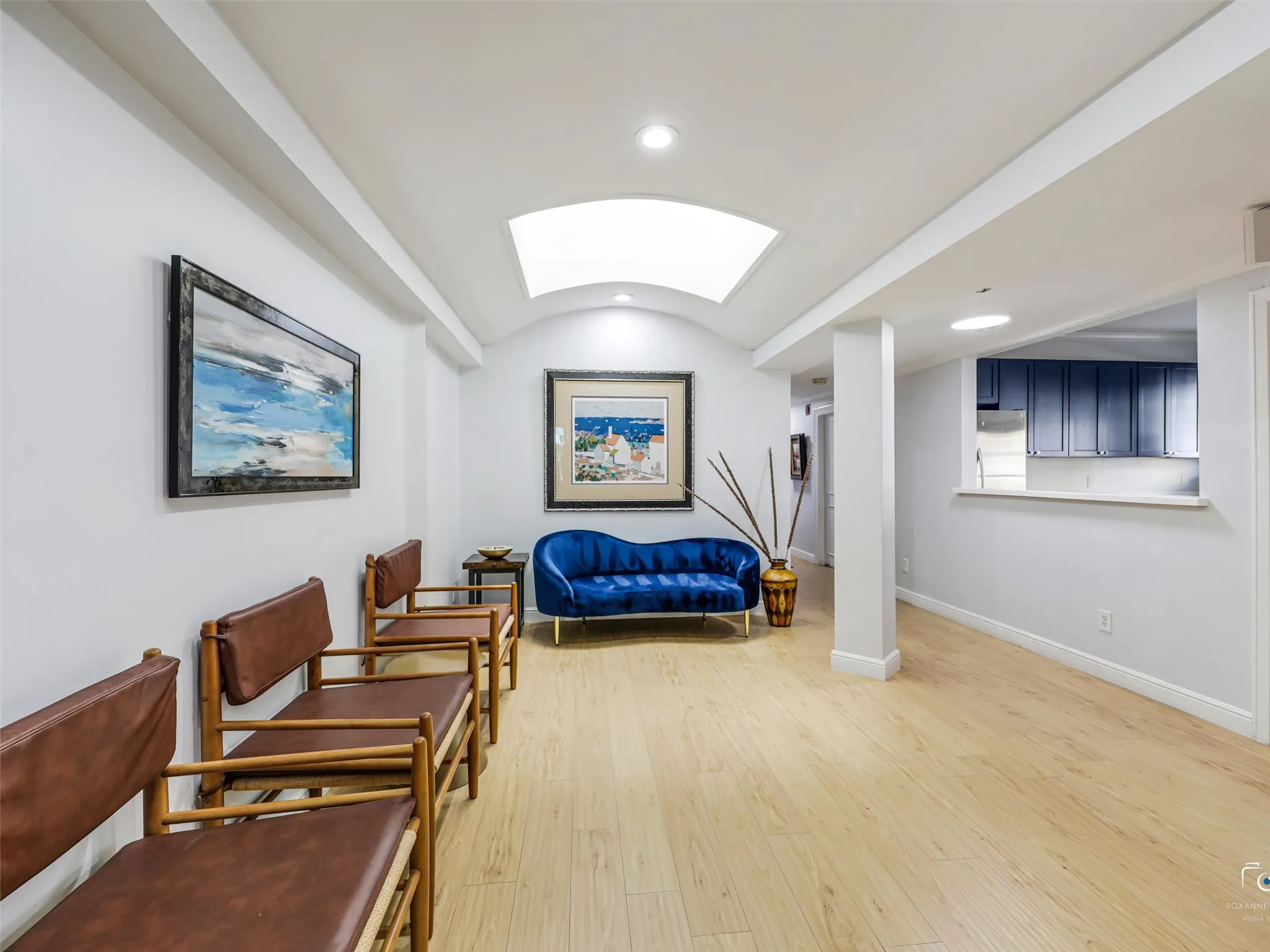 Lobby features seating, skylight and recessed lighting.