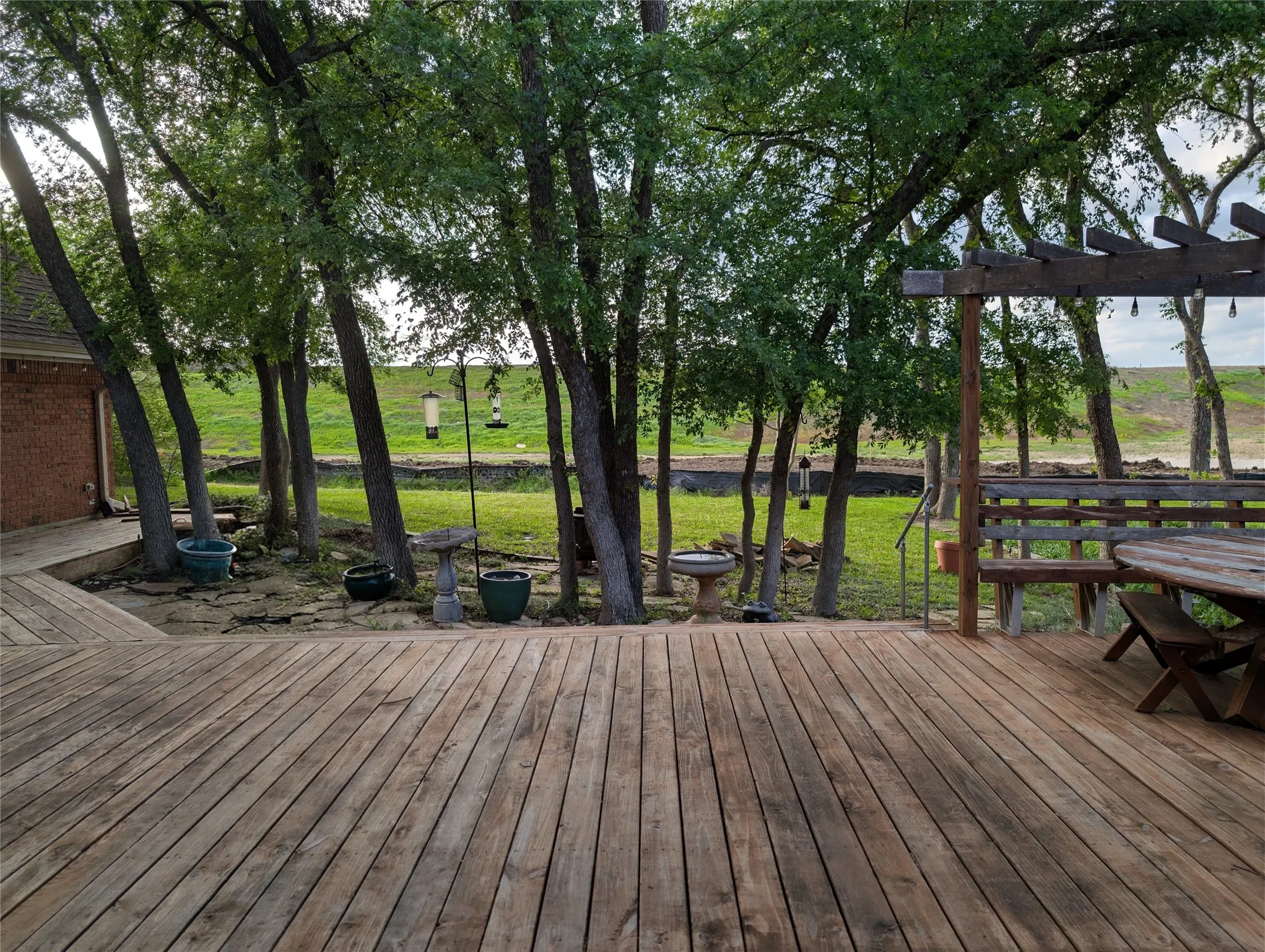 Spacious wood deck with perimeter pergola structure