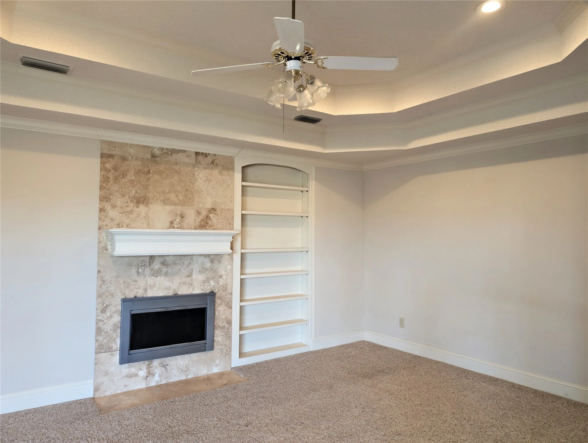 Tray ceiling with cove lighting and ceiling fan