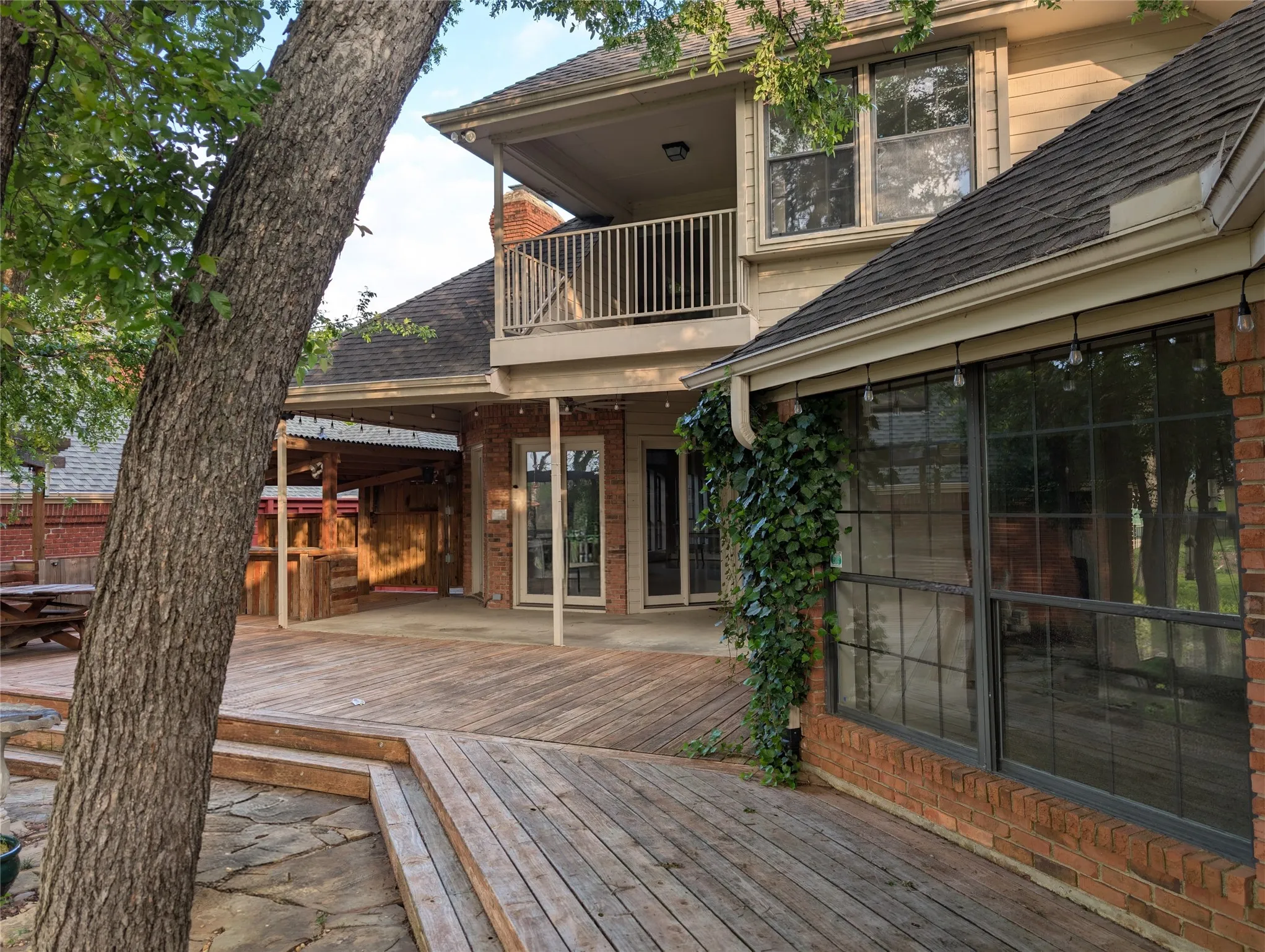 Multi-level wood-finish decking with stone paver accents