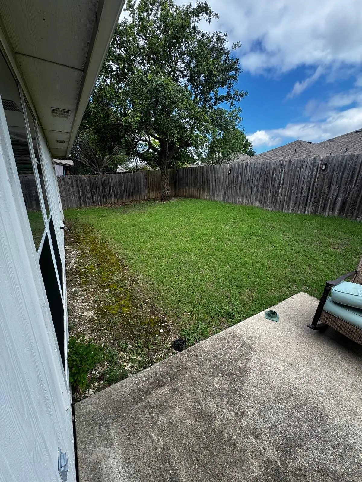 Private backyard featuring a concrete patio and a wooden privacy fence