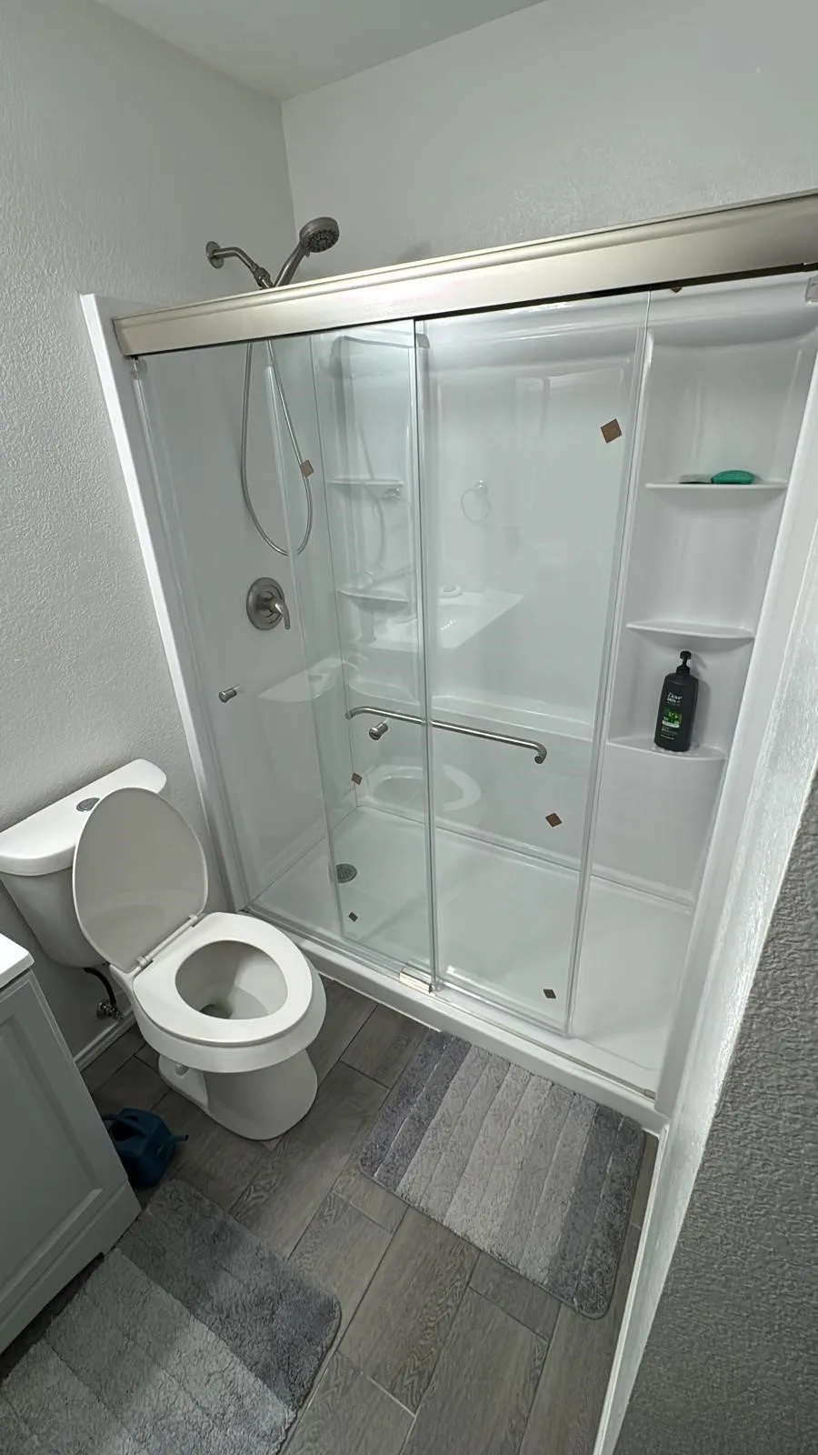 Walk-in shower with clear glass enclosure and sliding doors