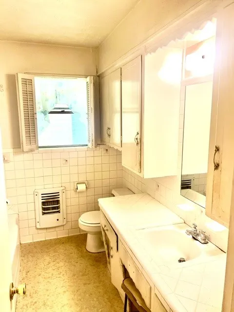 White tile vanity with integrated sink and chrome faucet