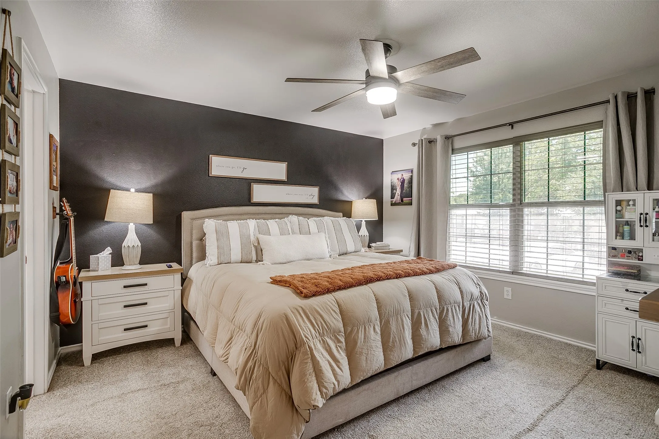 Spacious room featuring carpeted flooring and a contrasting accent wall