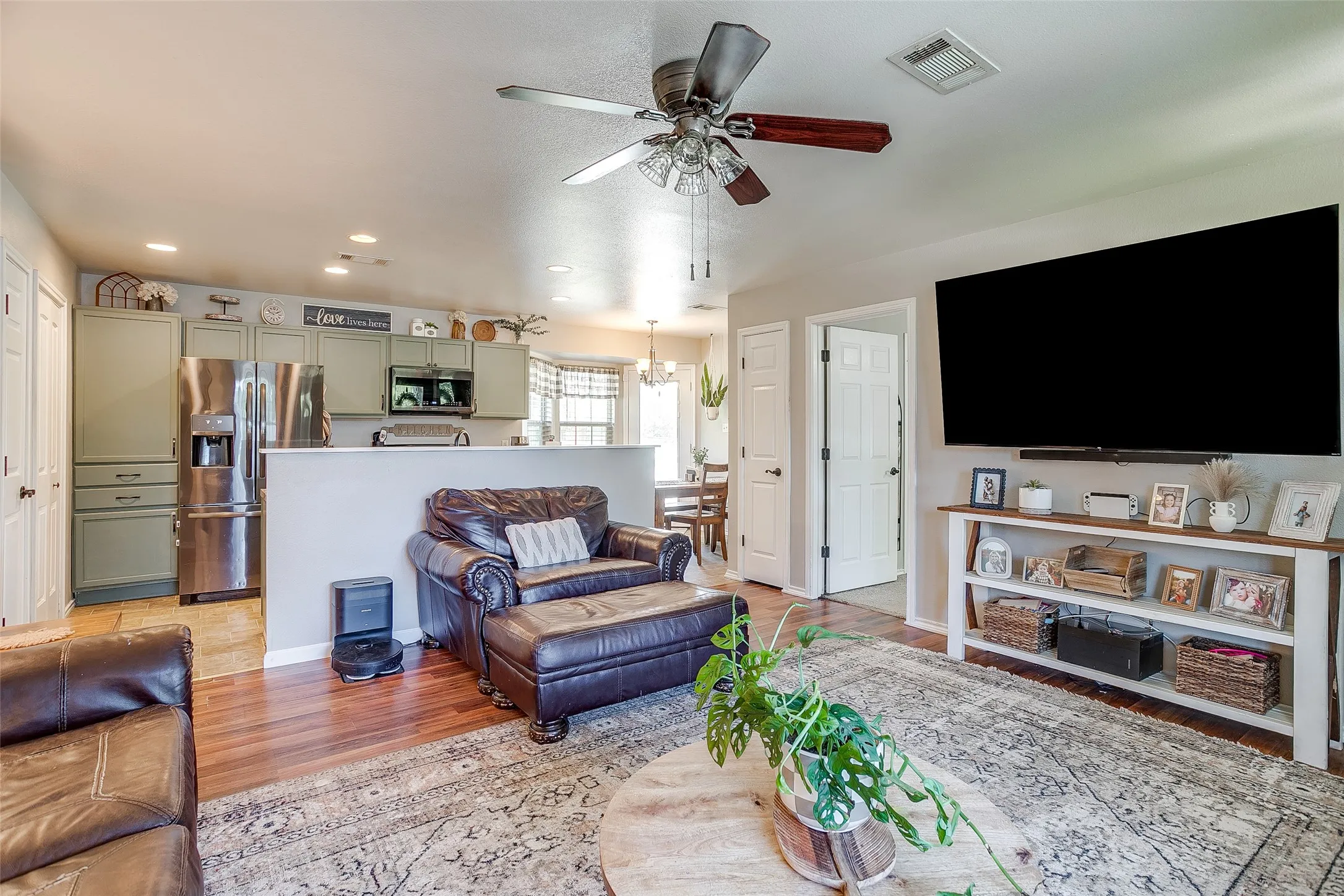 Open-concept living space featuring wood-finish flooring and a ceiling fan