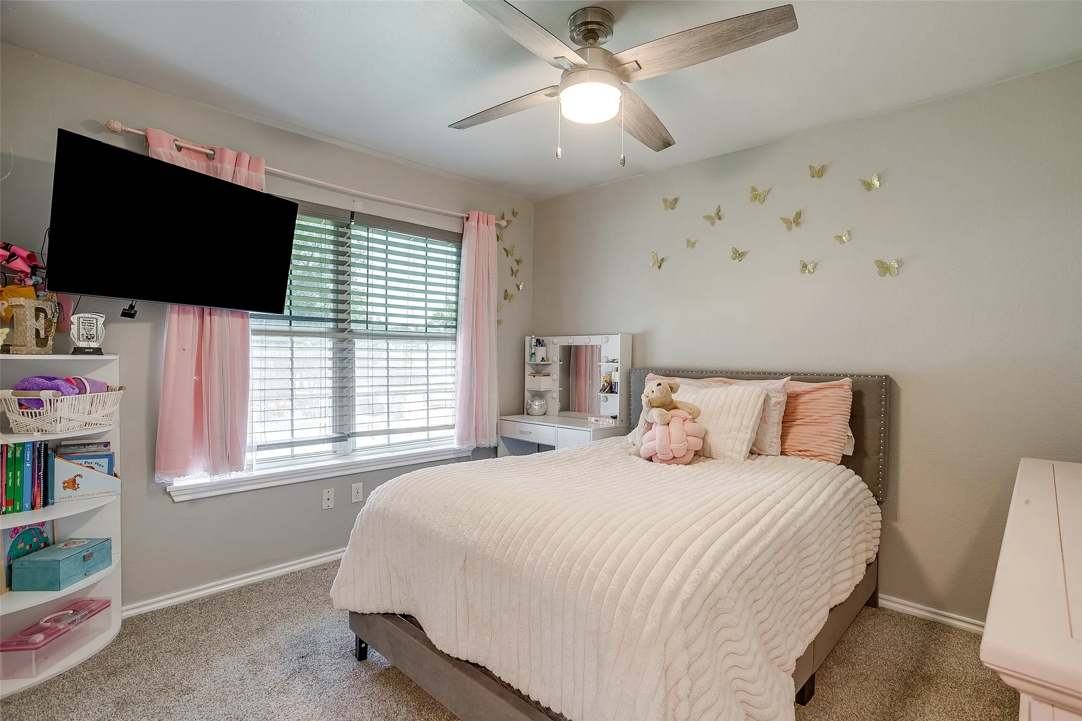 Bedroom featuring a ceiling fan with light fixture, window with blinds, and carpeted flooring