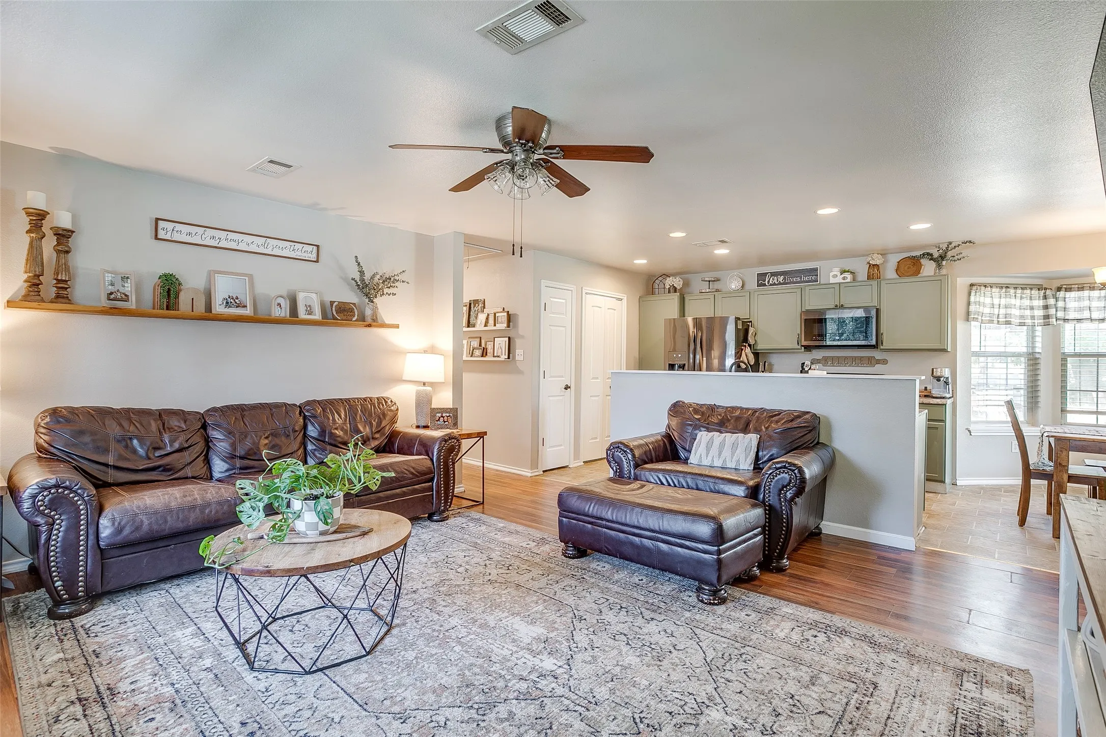 Open-concept living area featuring wood-finish flooring, recessed lighting, and a ceiling fan
