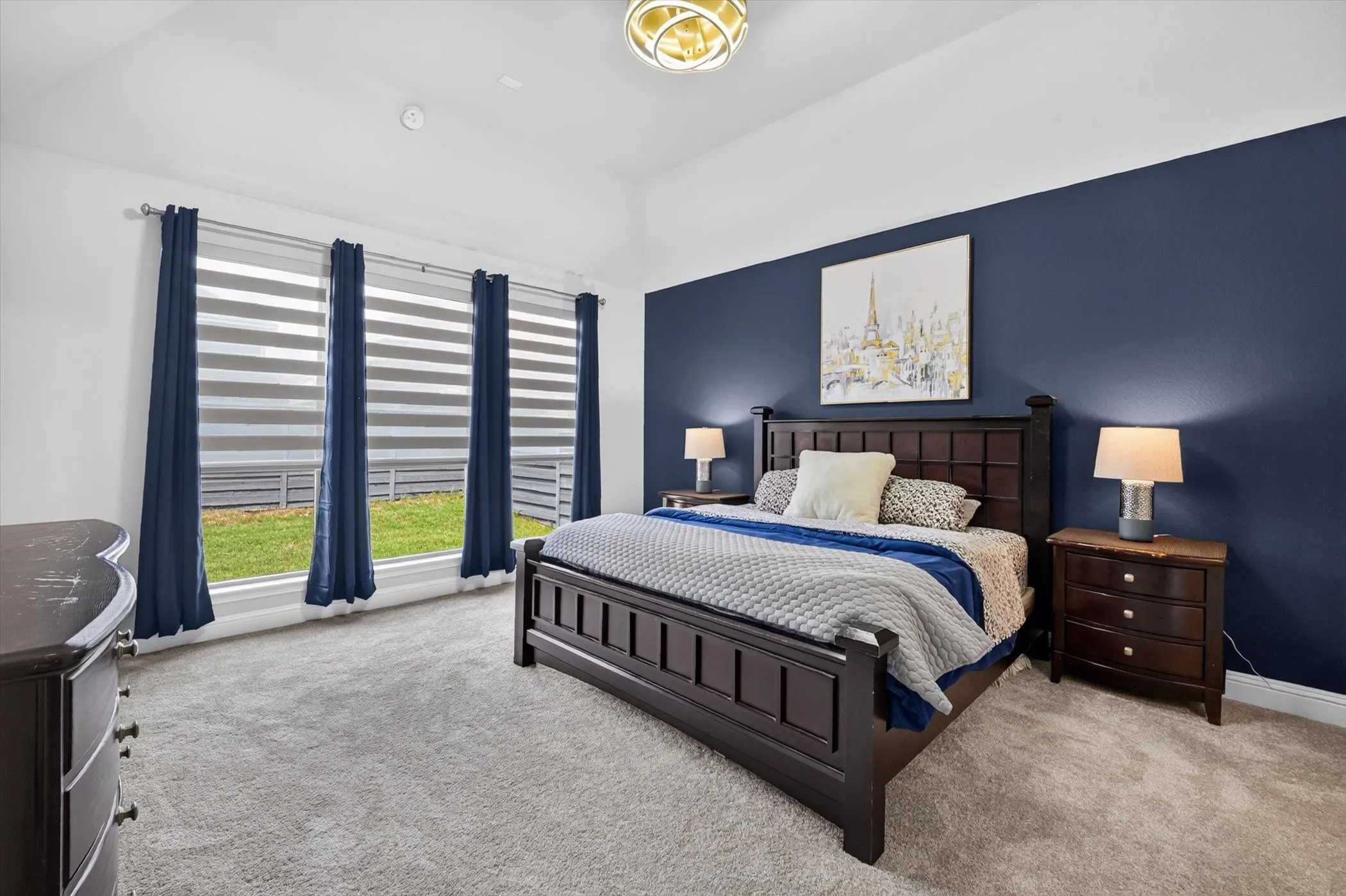 Light grey carpeting throughout with a dark blue accent wall