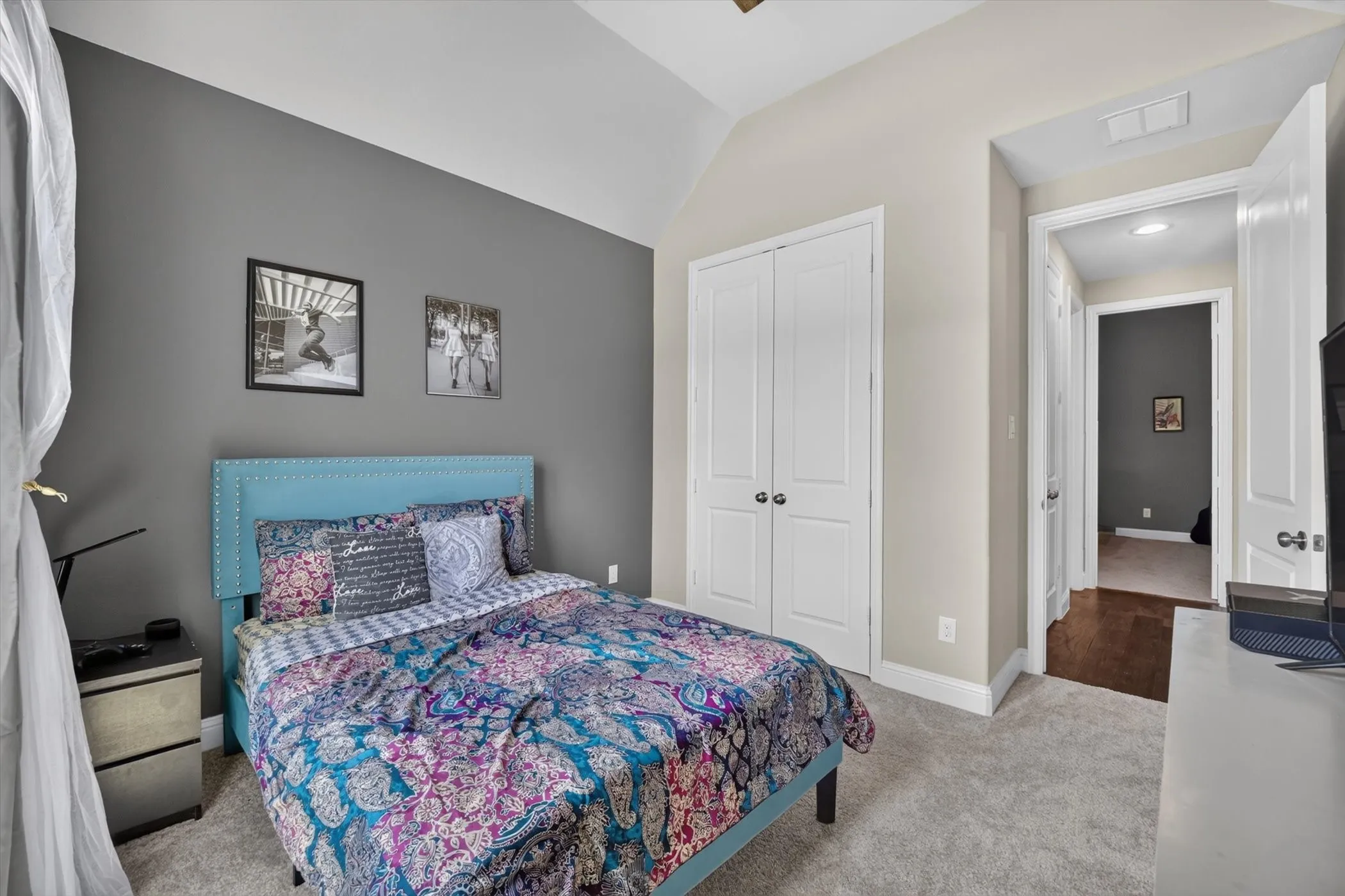Bedroom featuring a vaulted ceiling and neutral-toned walls