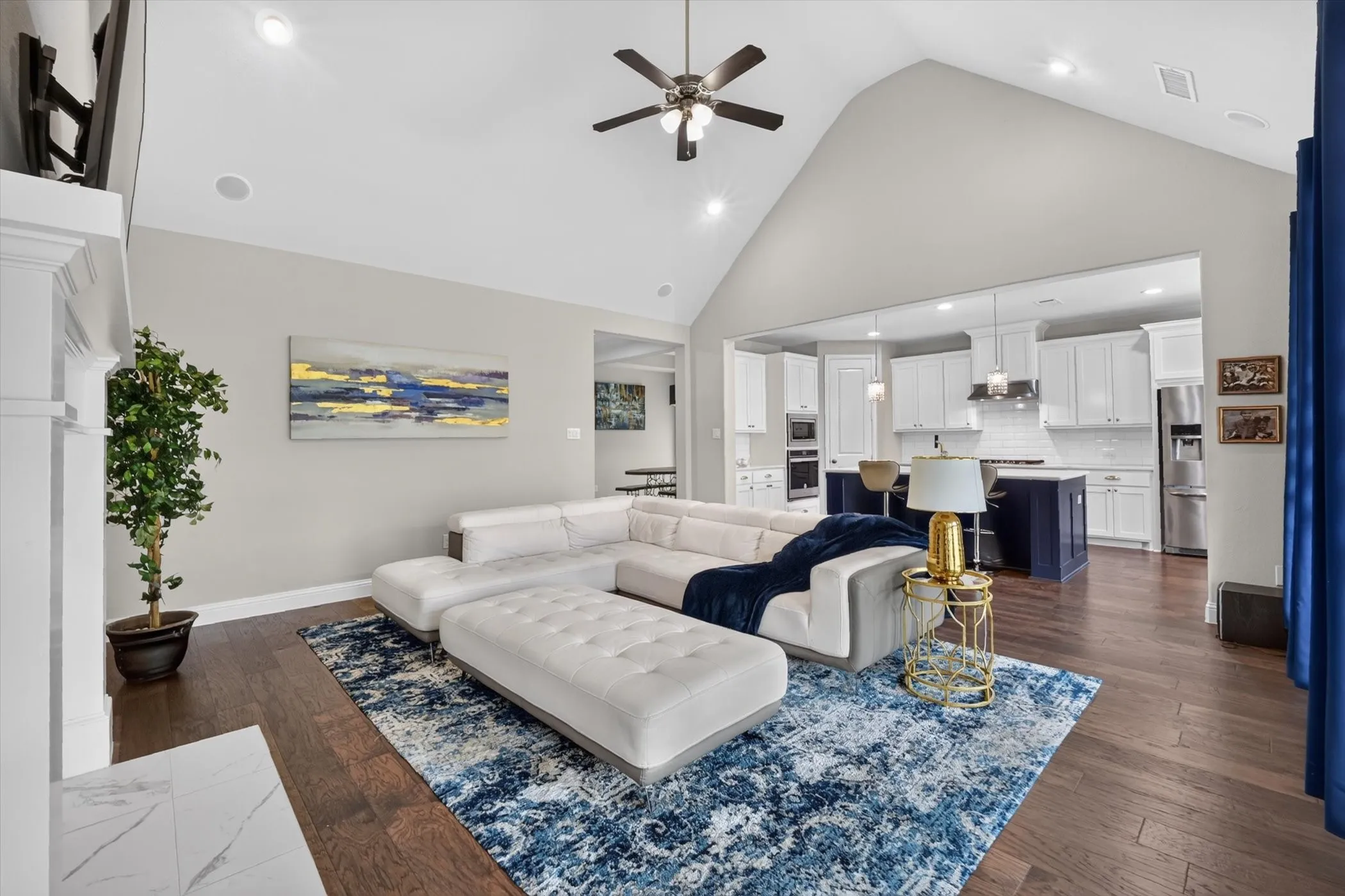 Open-concept living area featuring a vaulted ceiling and dark wood-finish flooring