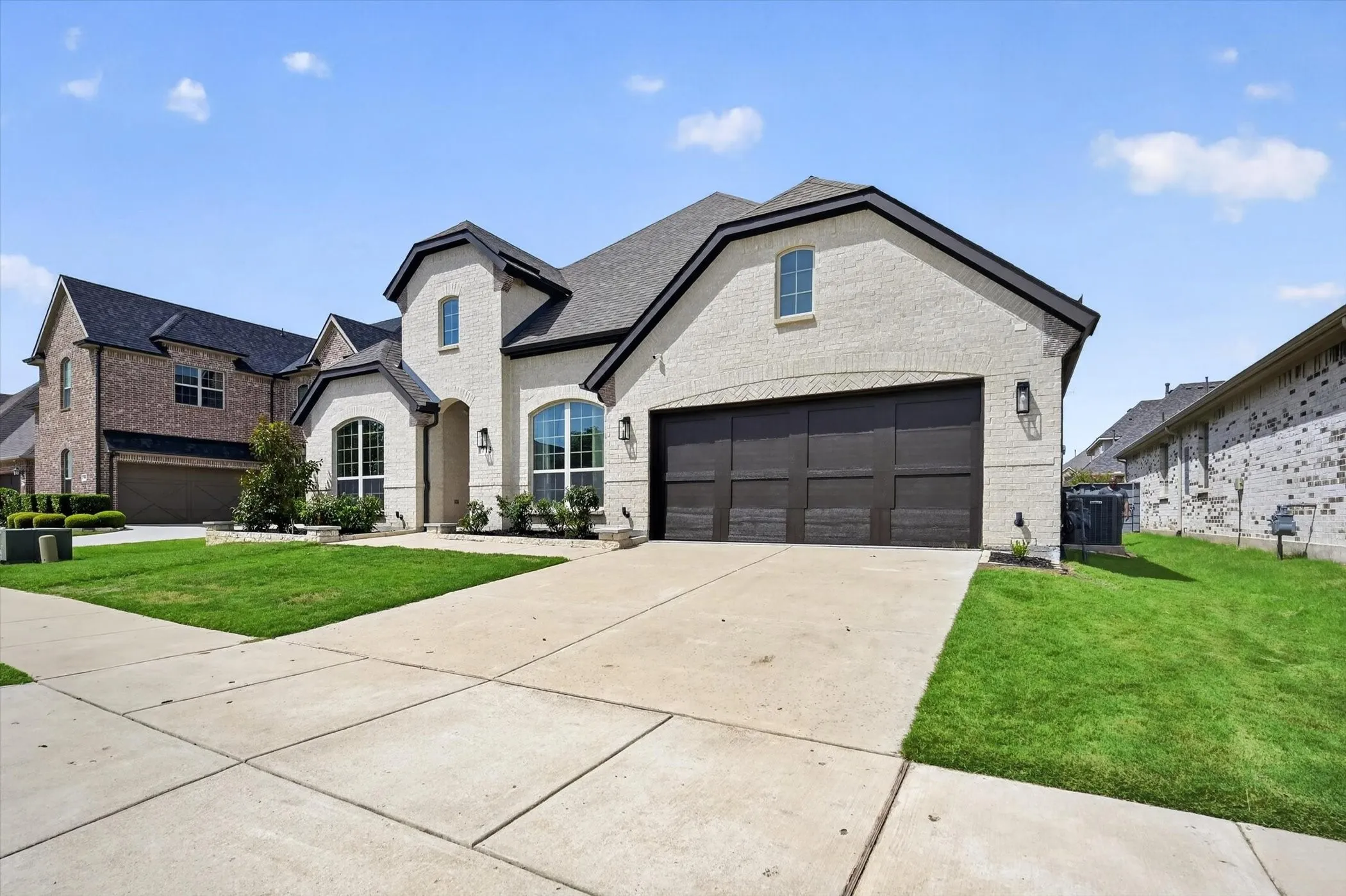 Contemporary architectural design with light-colored brick facade and dark trim
