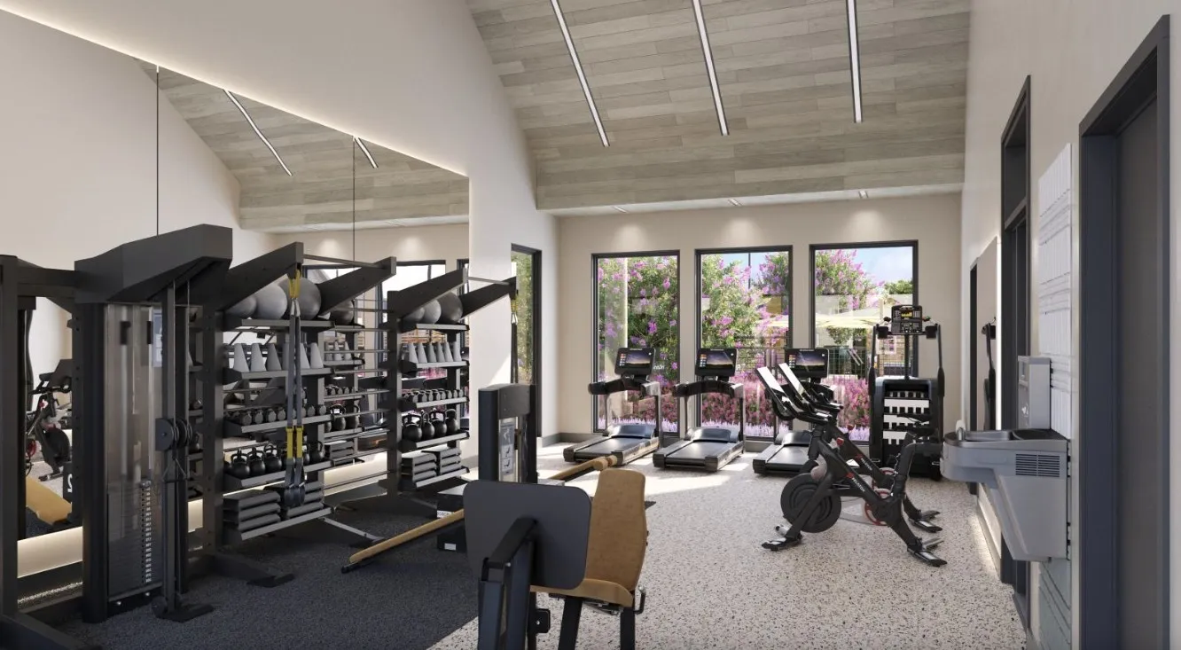 Gym featuring high vaulted ceiling, light colored carpet, and rail lighting