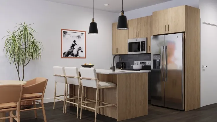 Kitchen with appliances with stainless steel finishes, pendant lighting, light brown cabinetry, and dark wood finished floors