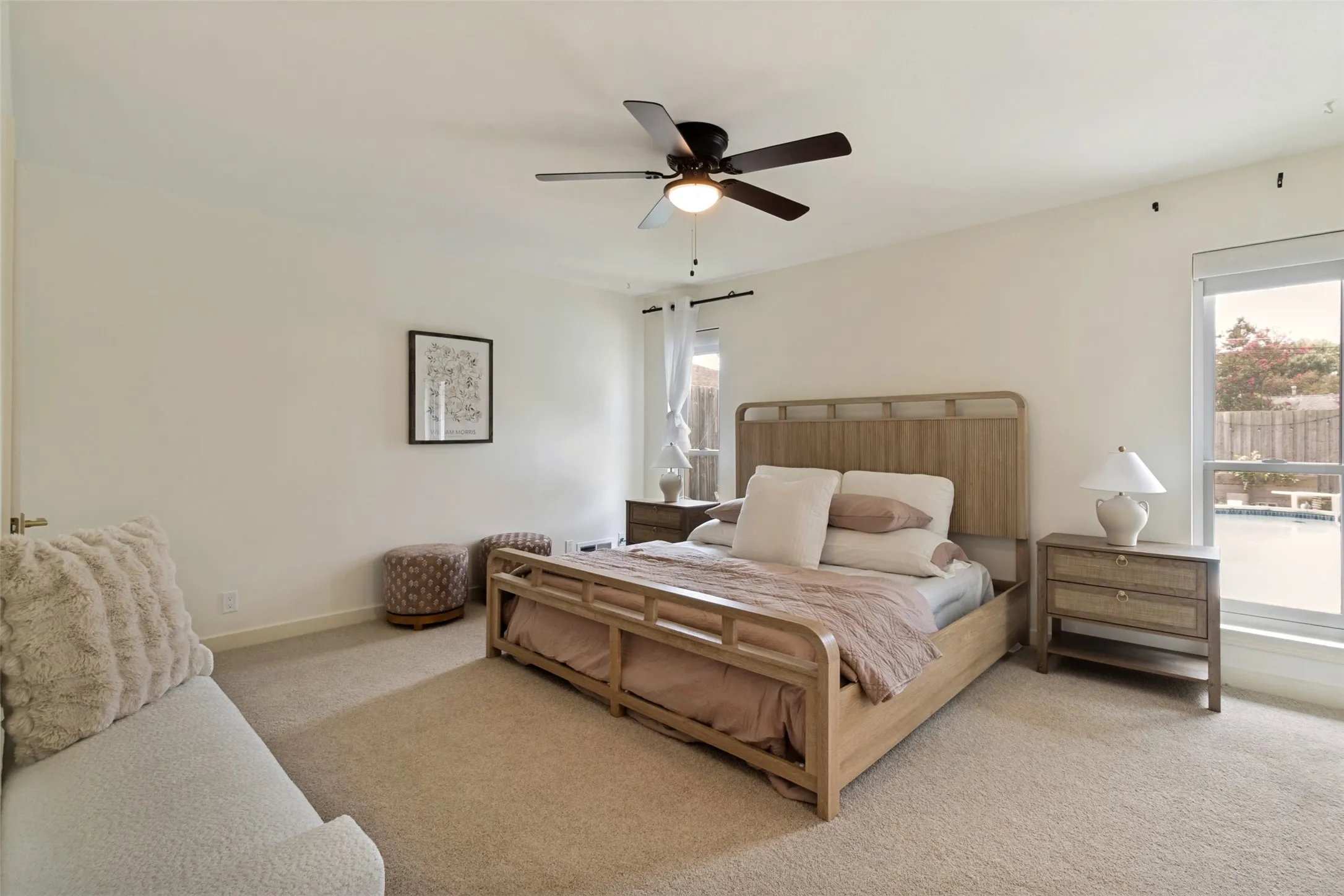 Primary Bedroom with walk in closet, new electronic shades and views of backyard