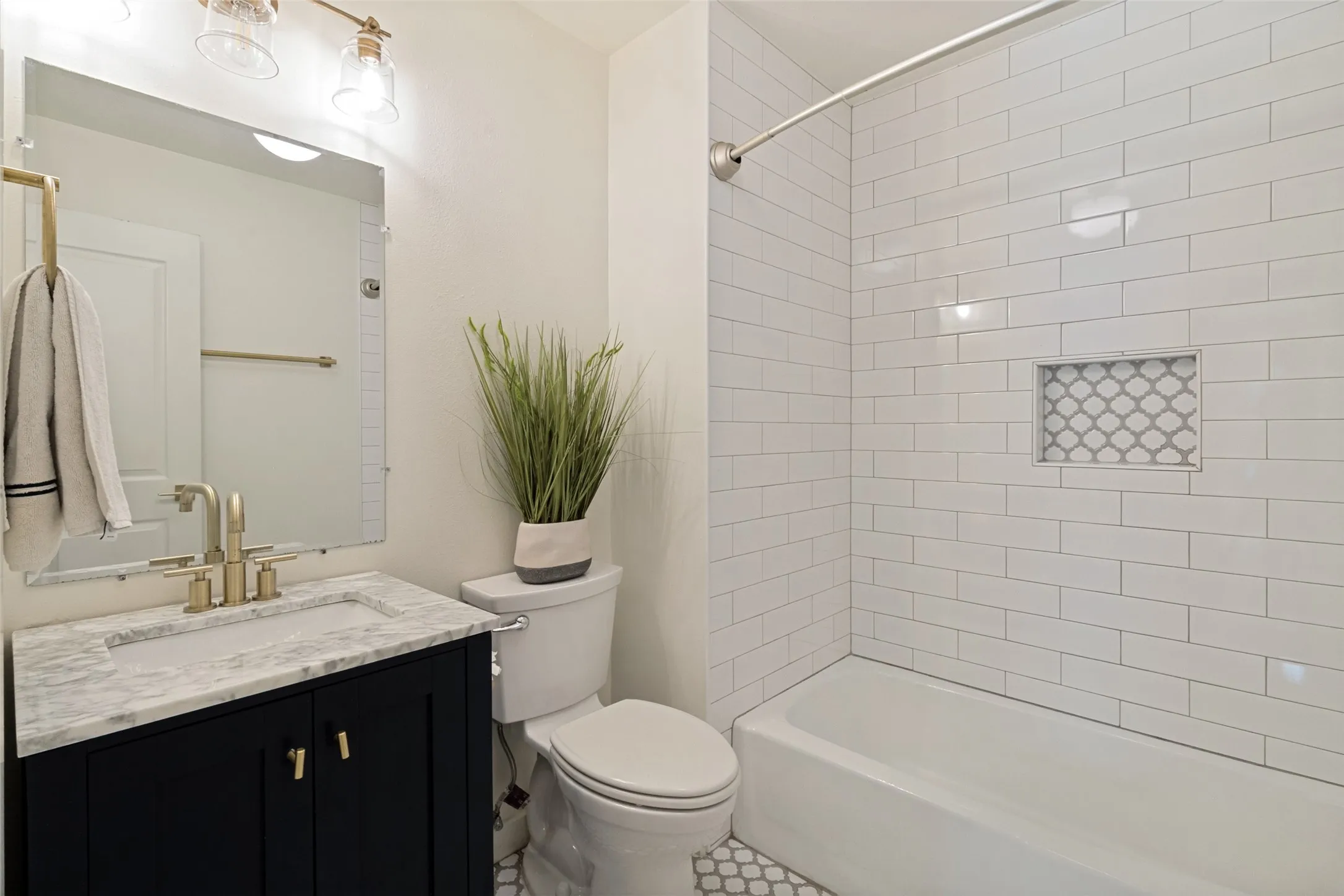 Secondary full bathroom with updated tile