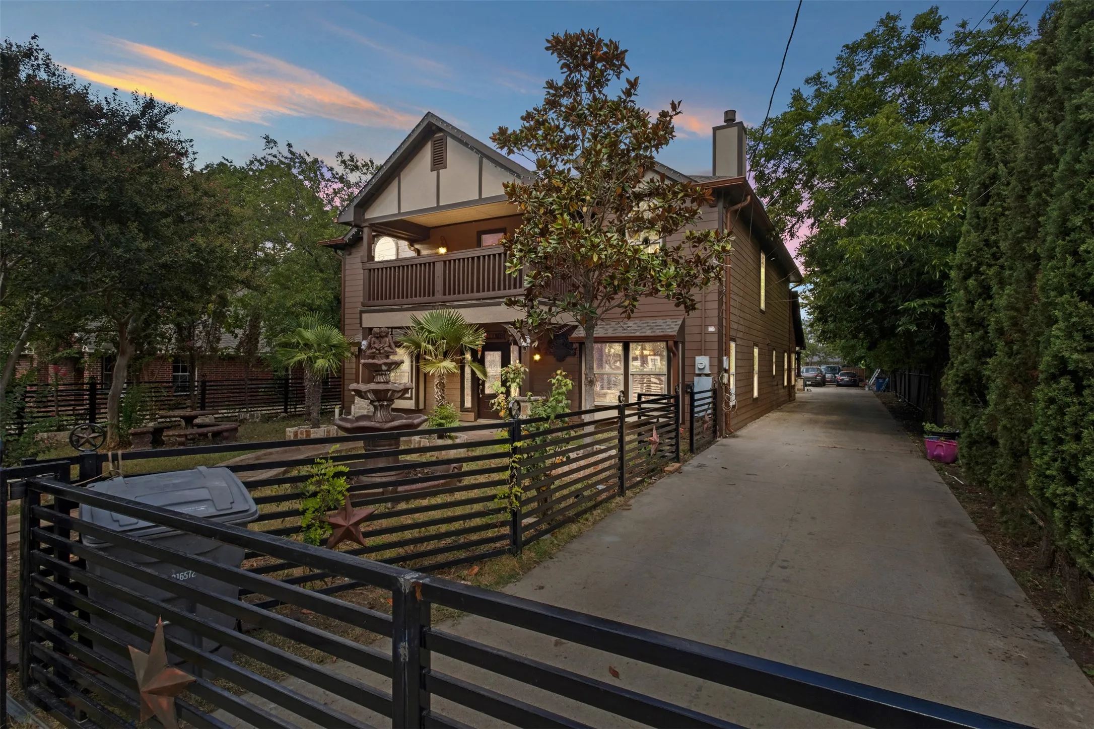 Two-story exterior with dark wood-finish siding and white trim accents