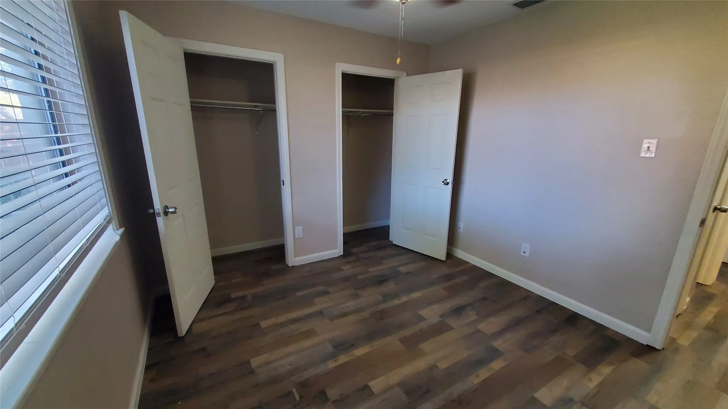 Bedroom 2 with large pass through closet space and ceiling fan.