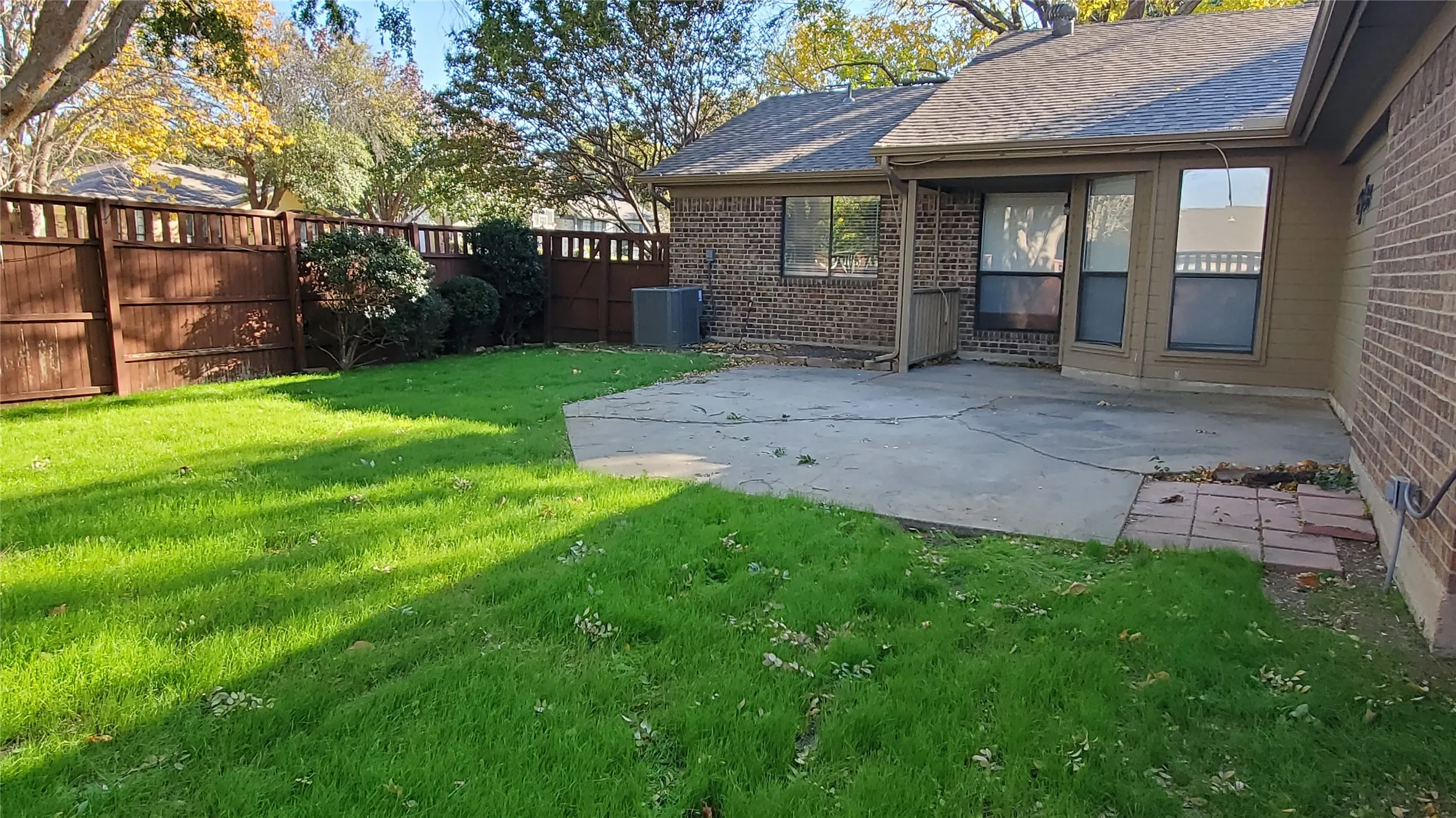 View of yard with a patio and central AC unit