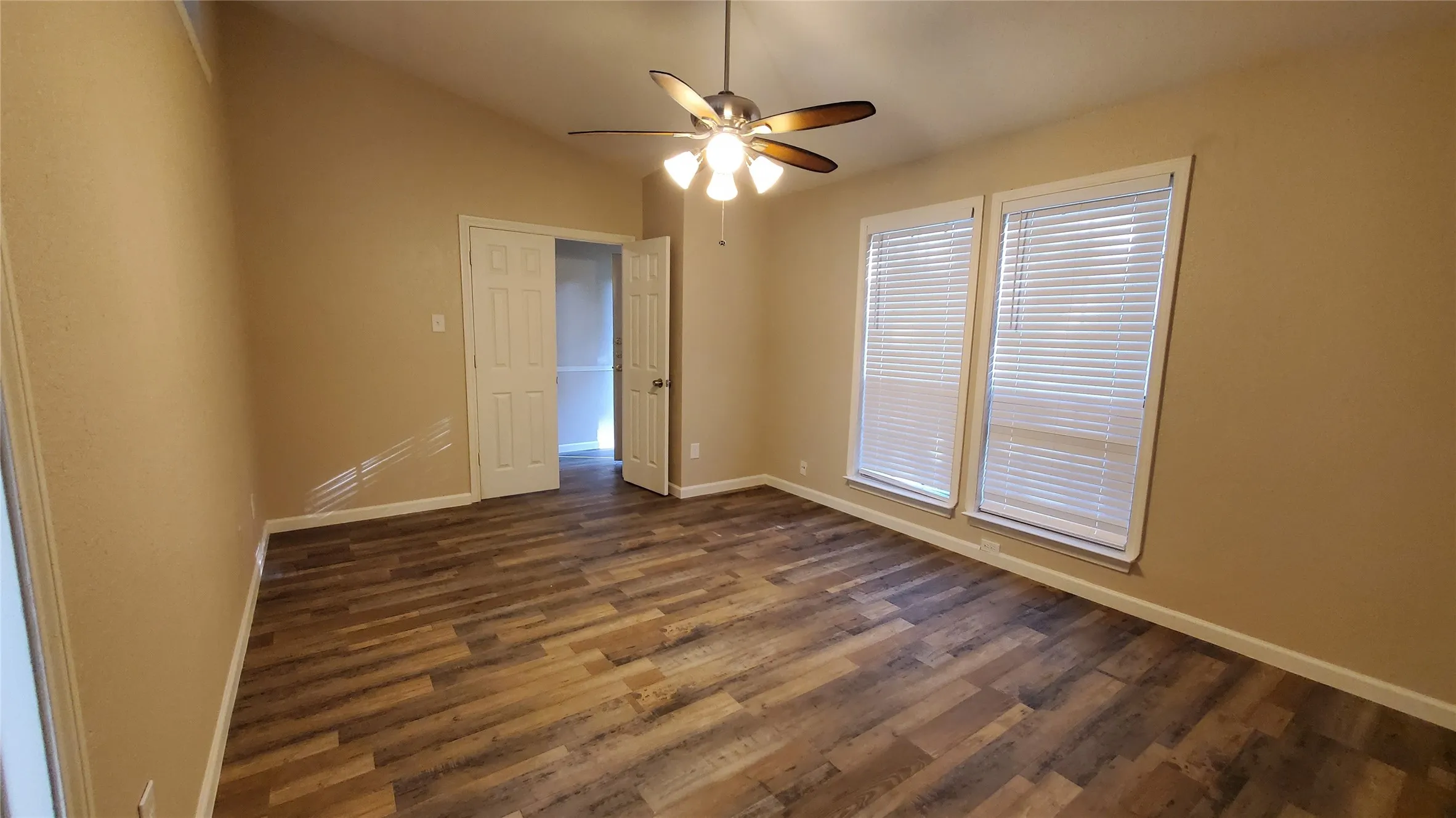 Unfurnished room featuring ceiling fan, dark hardwood / wood-style flooring, and lofted ceiling
